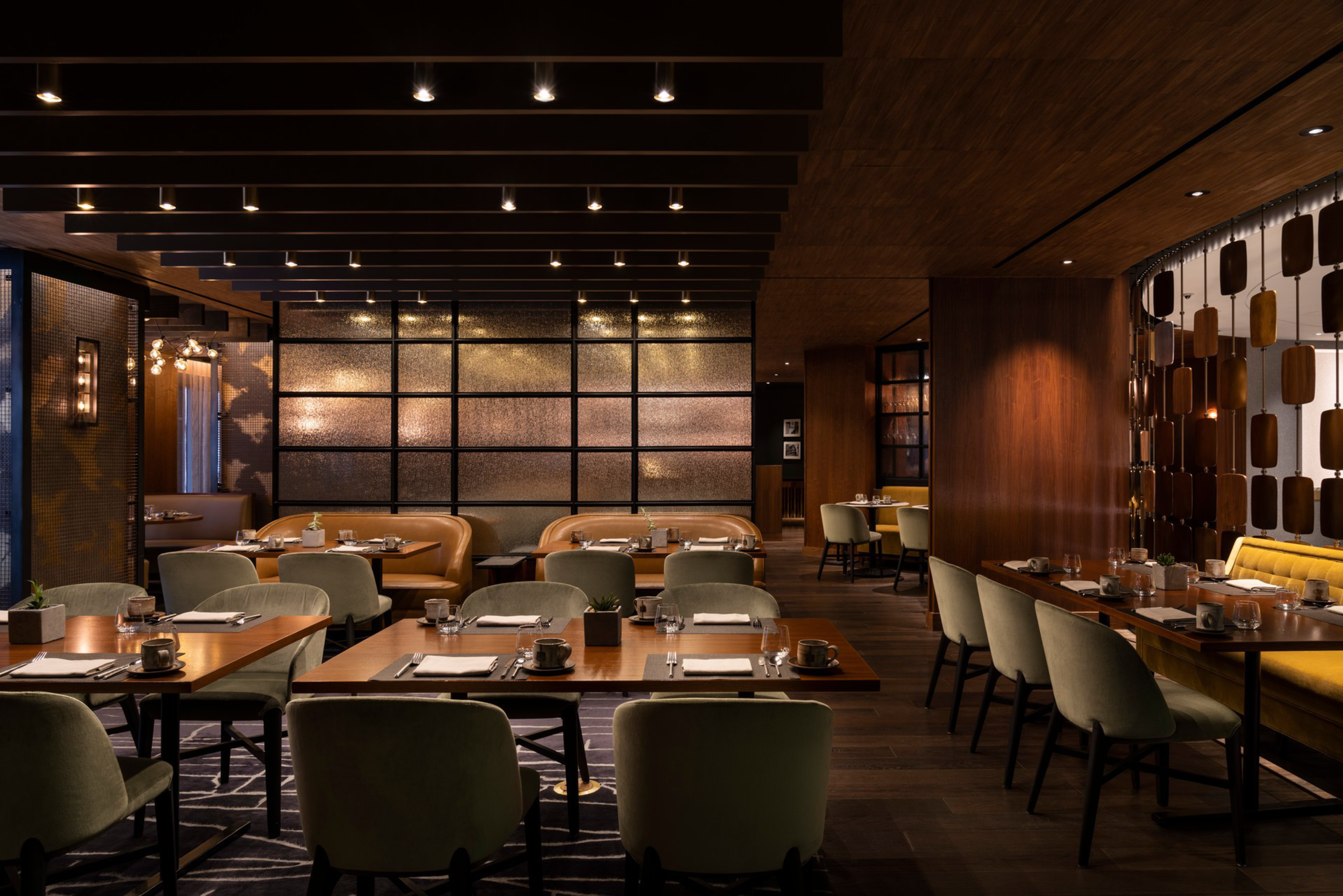San Francisco restaurant Orafo's dining room feeatures velvet chairs and dim lighting. 
