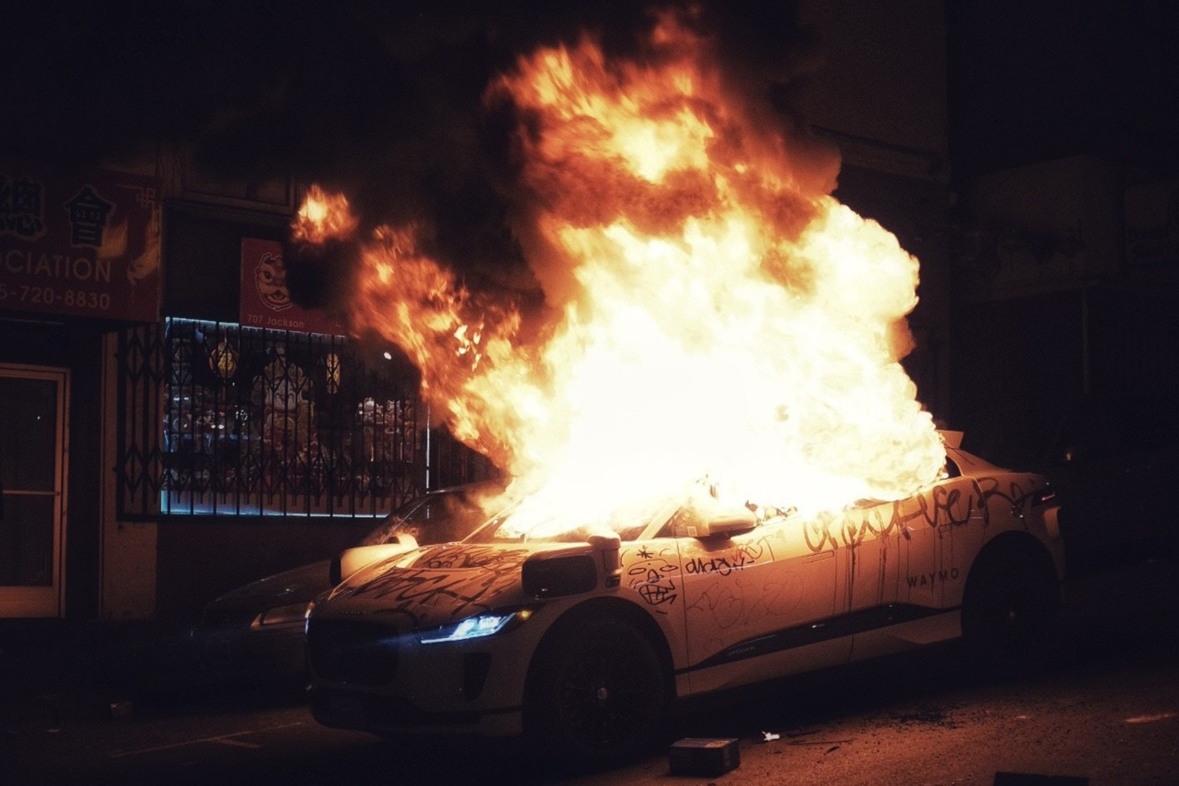 Flames engulf a Waymo.