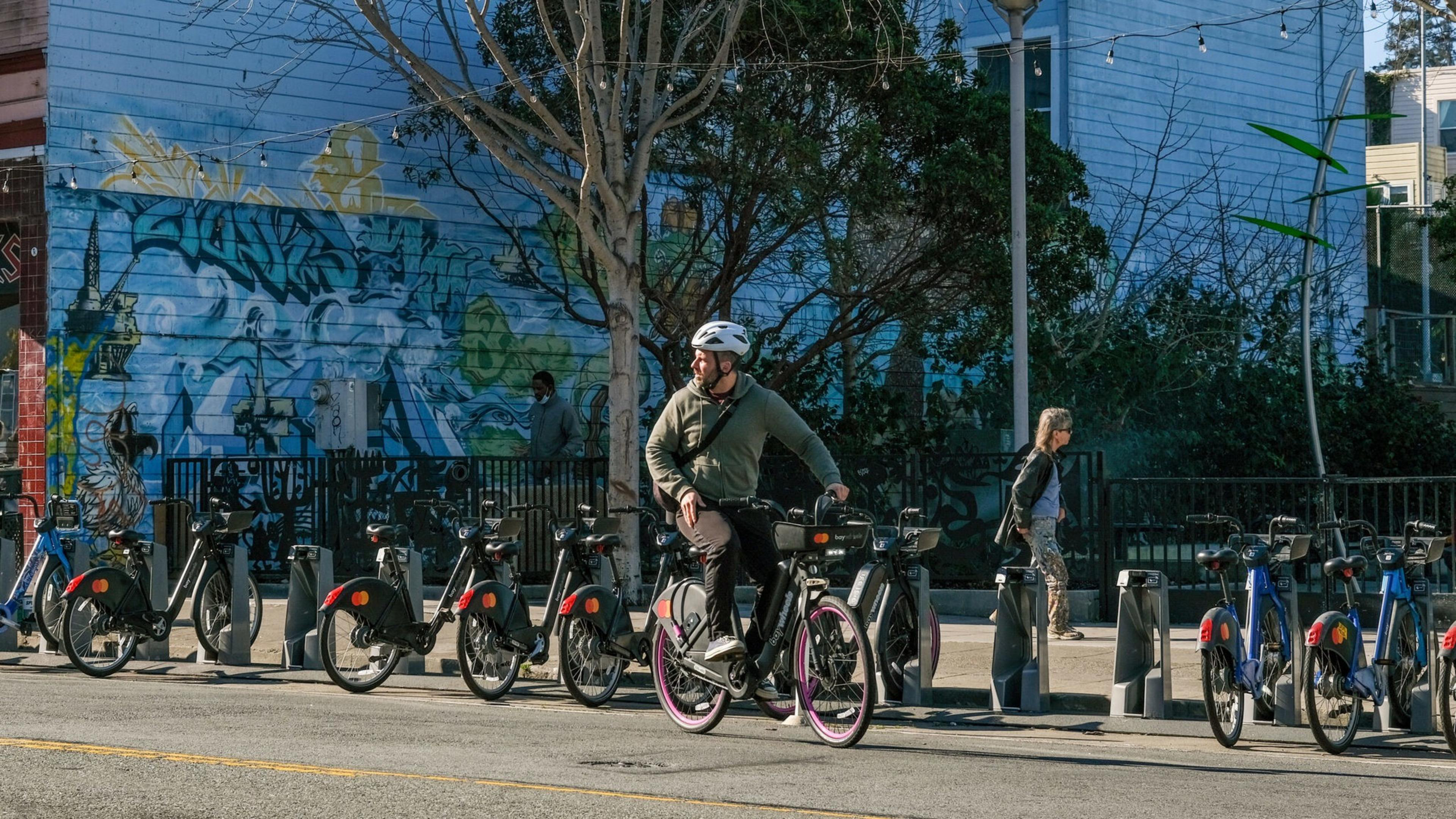 A person is seen riding a Lyft Bike.
