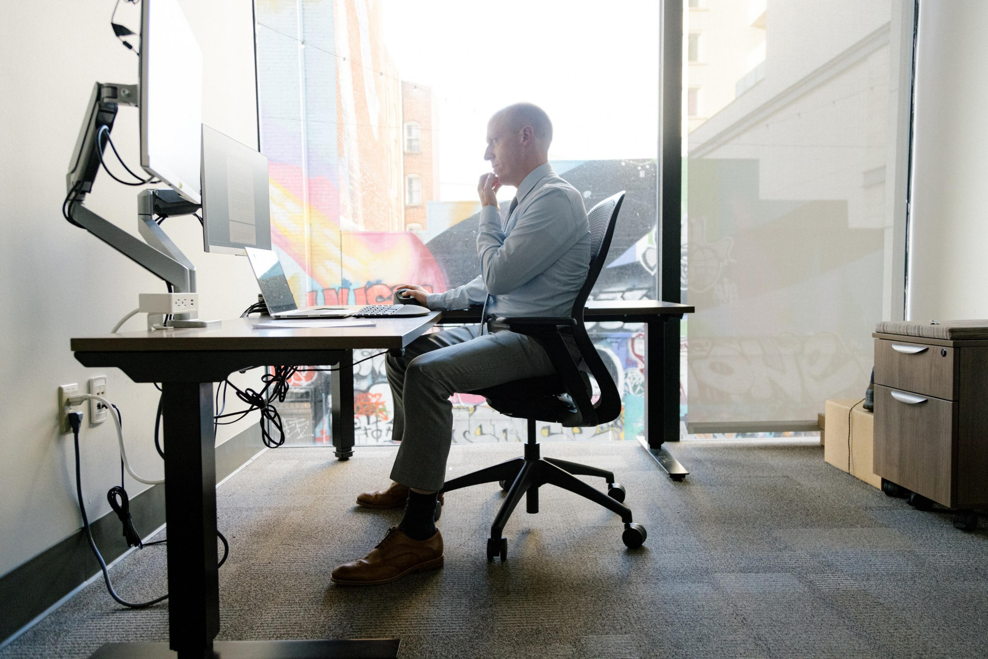 Patrick Ford sits at a desk.