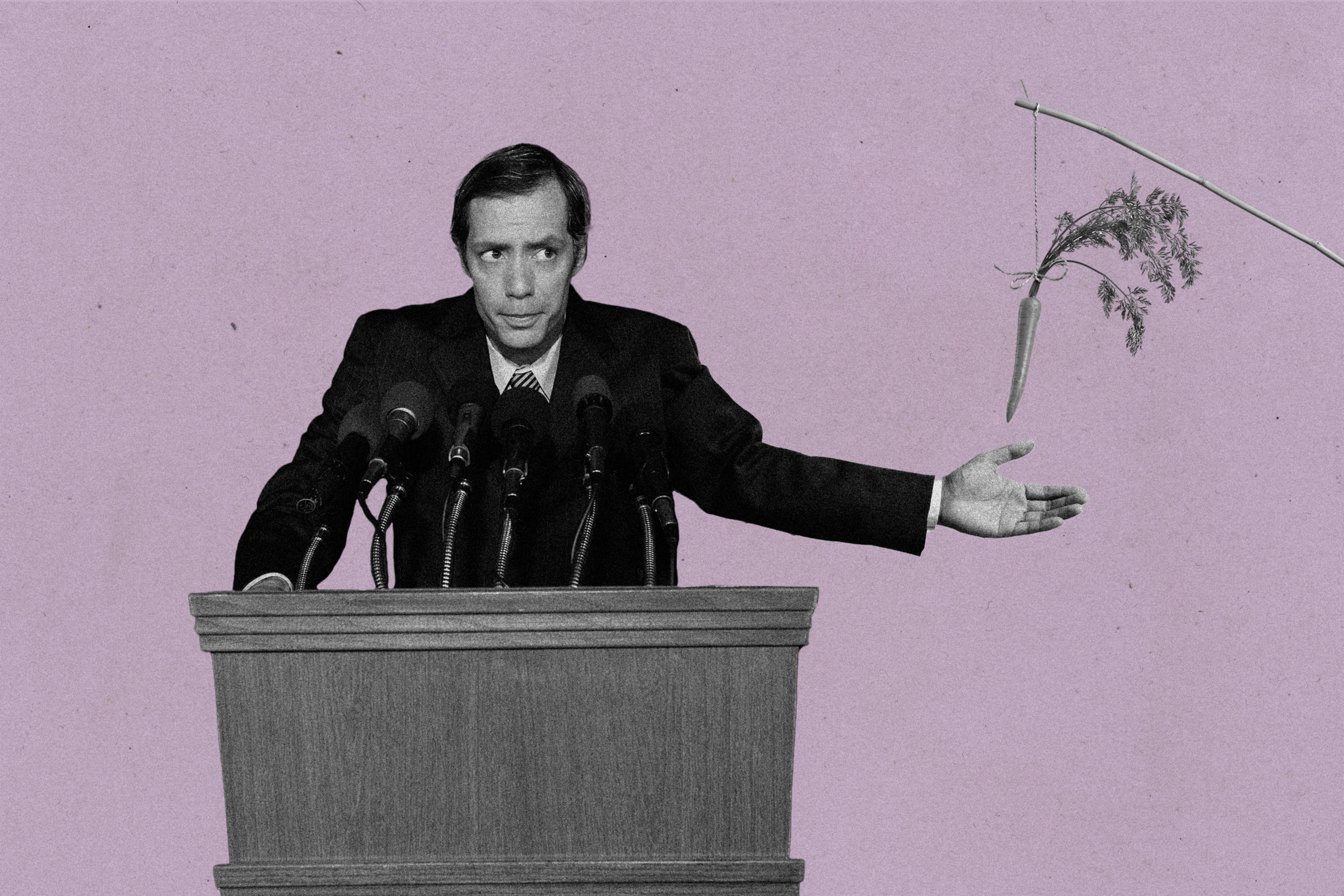 A man standing at a podium catching a carrot
