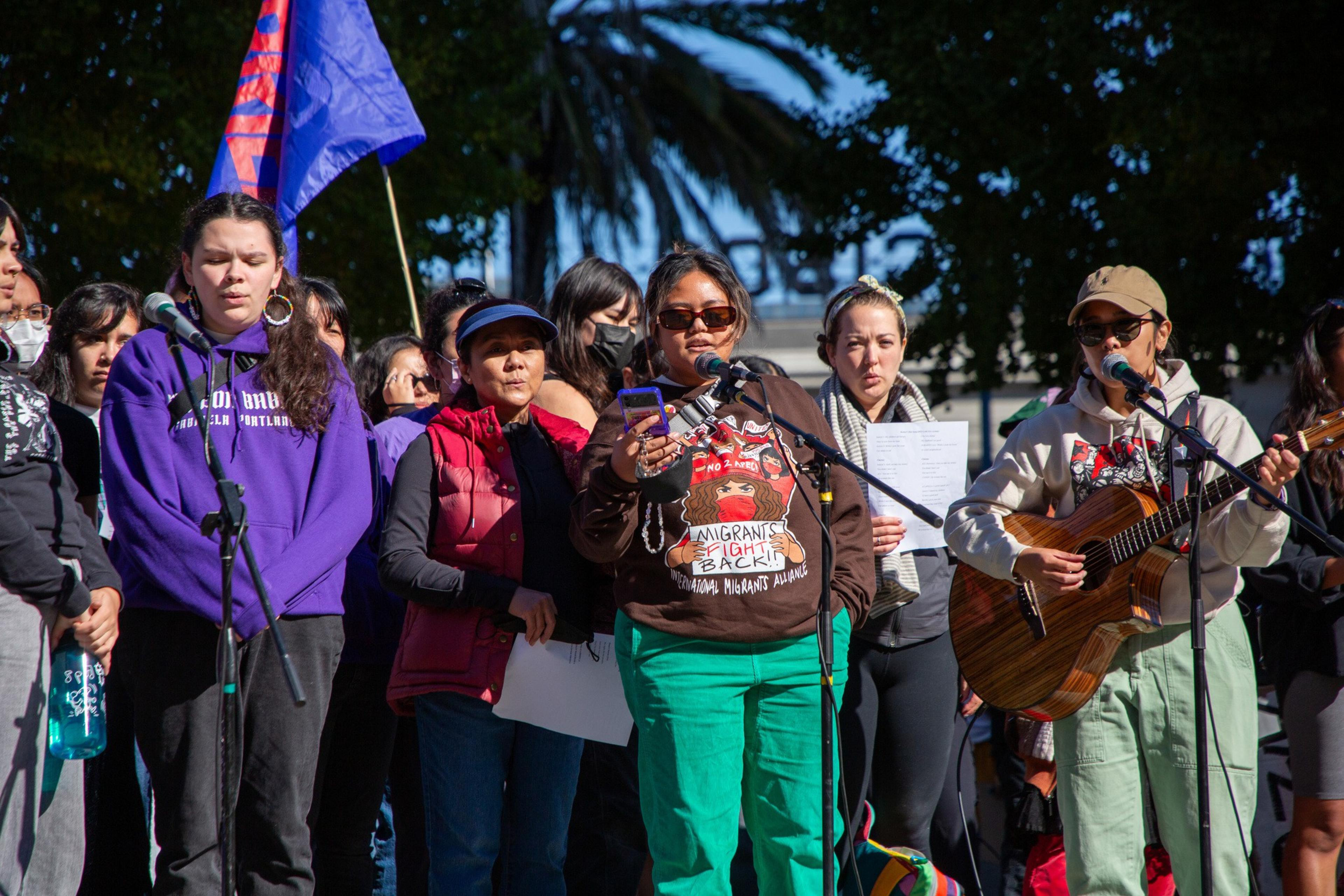 At the No 2 APEC protest, members of Gabriela USA sang, held signs, and were accompanied by a guitarist.