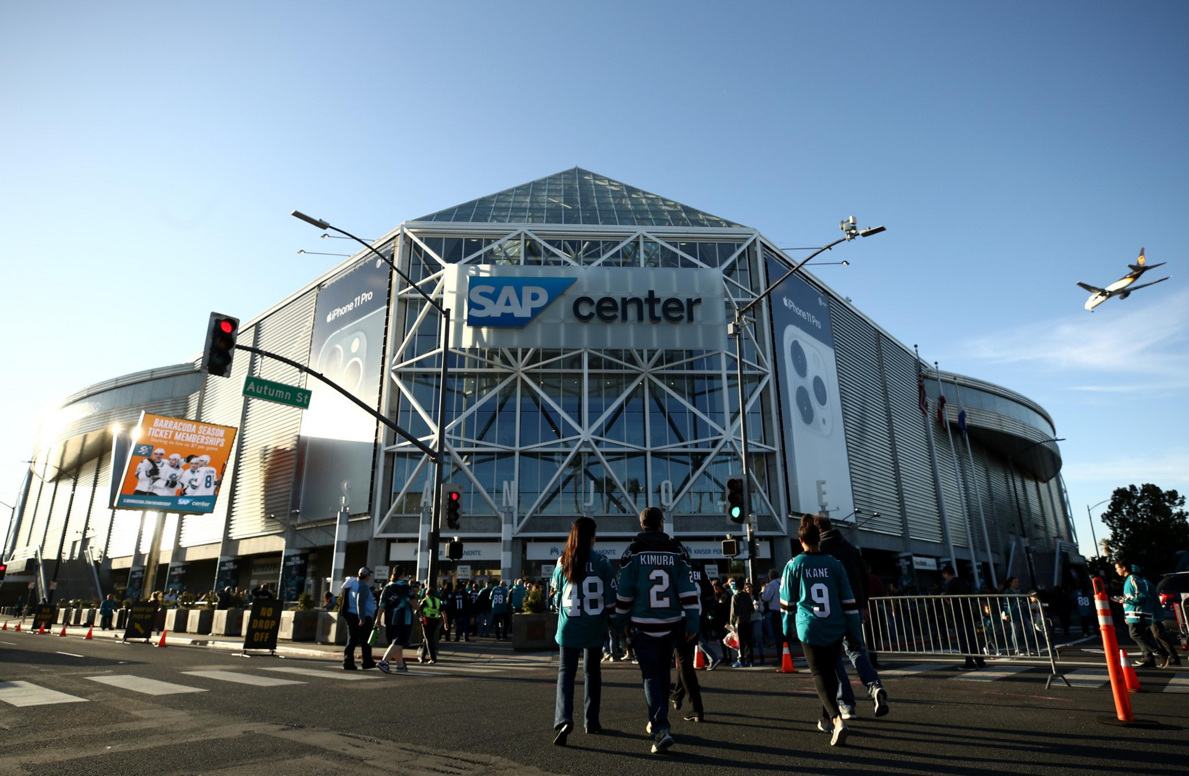 Fans walk to a stadium