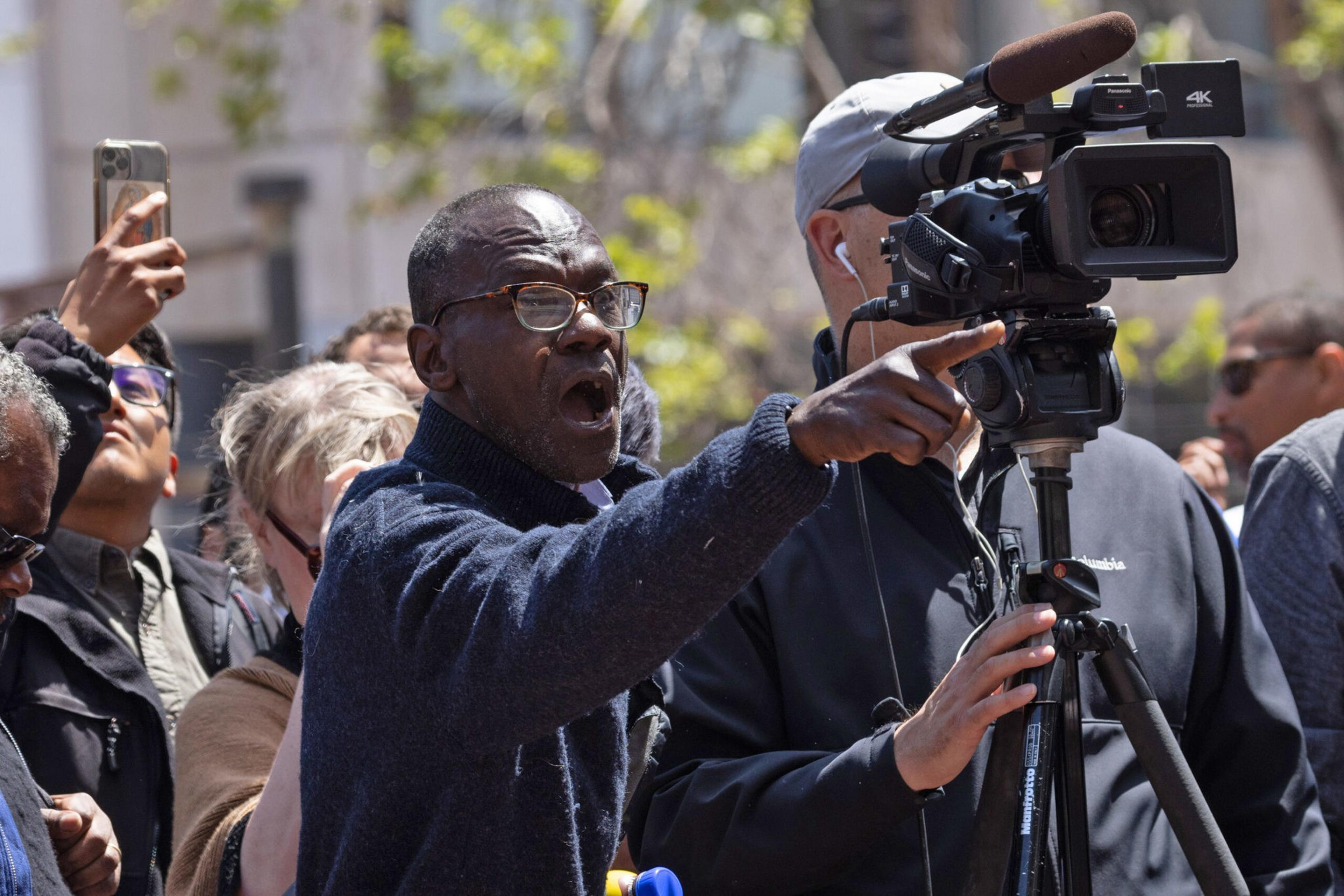 A man shouts at the UN Plaza press conference