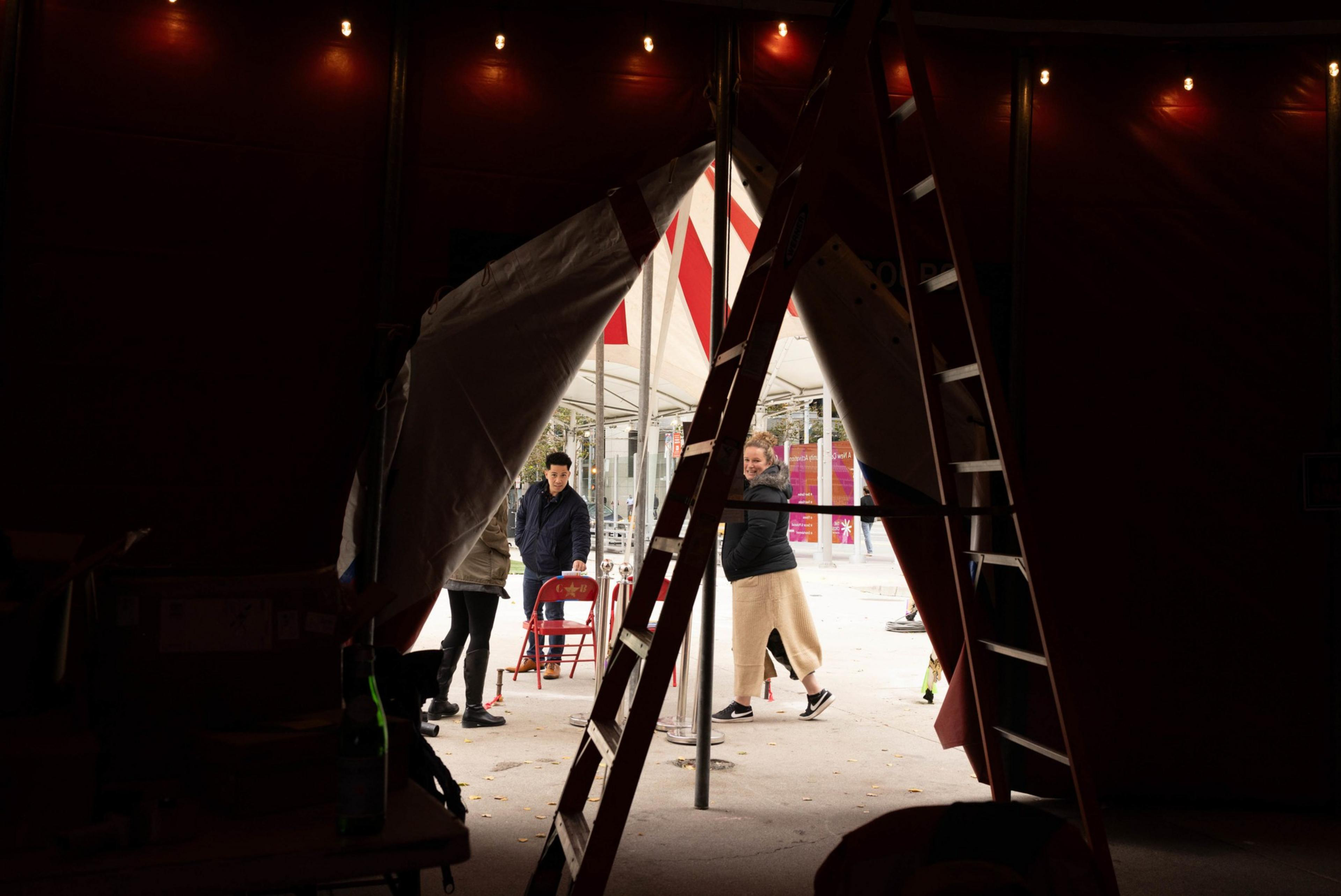 People outside the tent setting up for the circus.