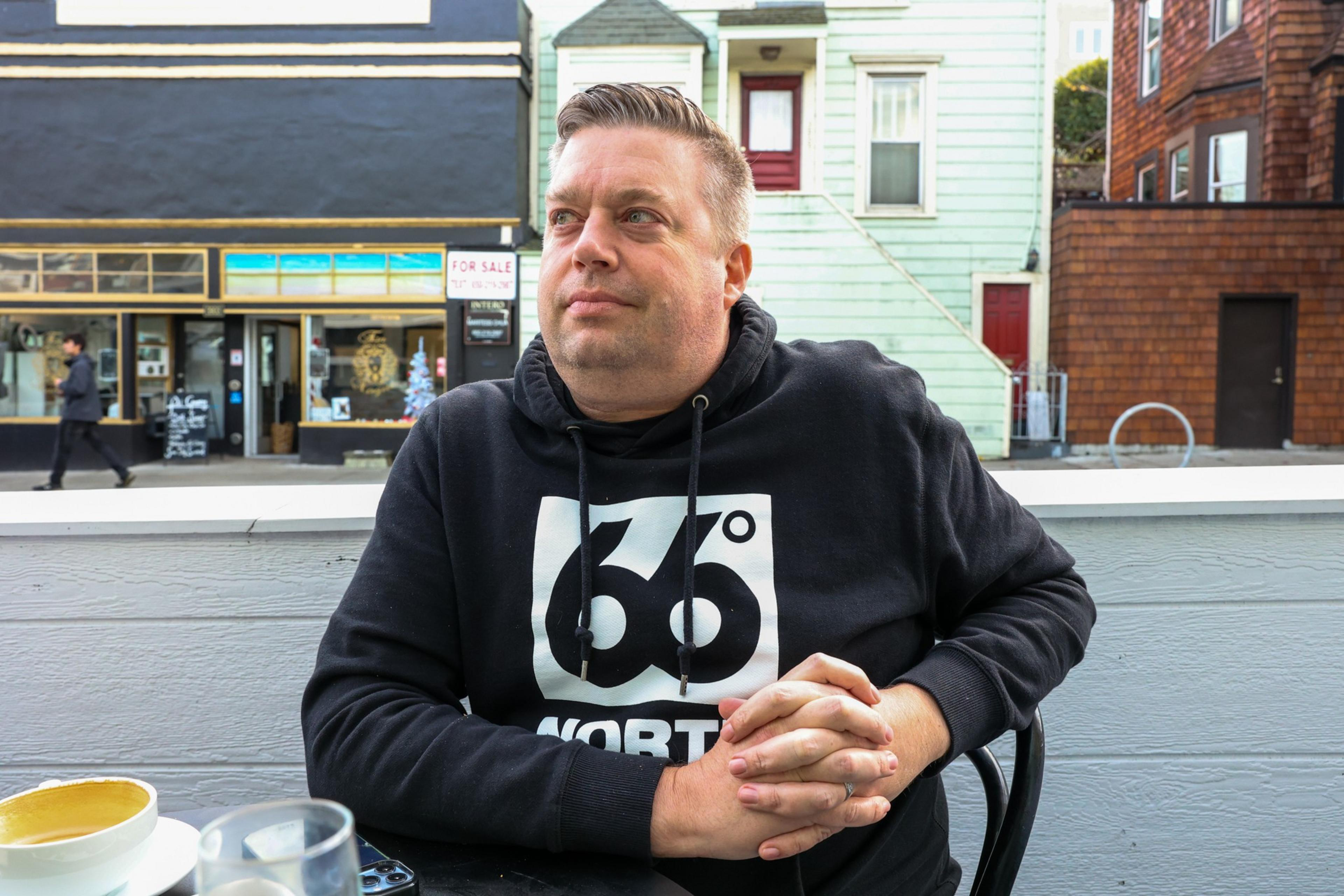 A man sits in a parklet.