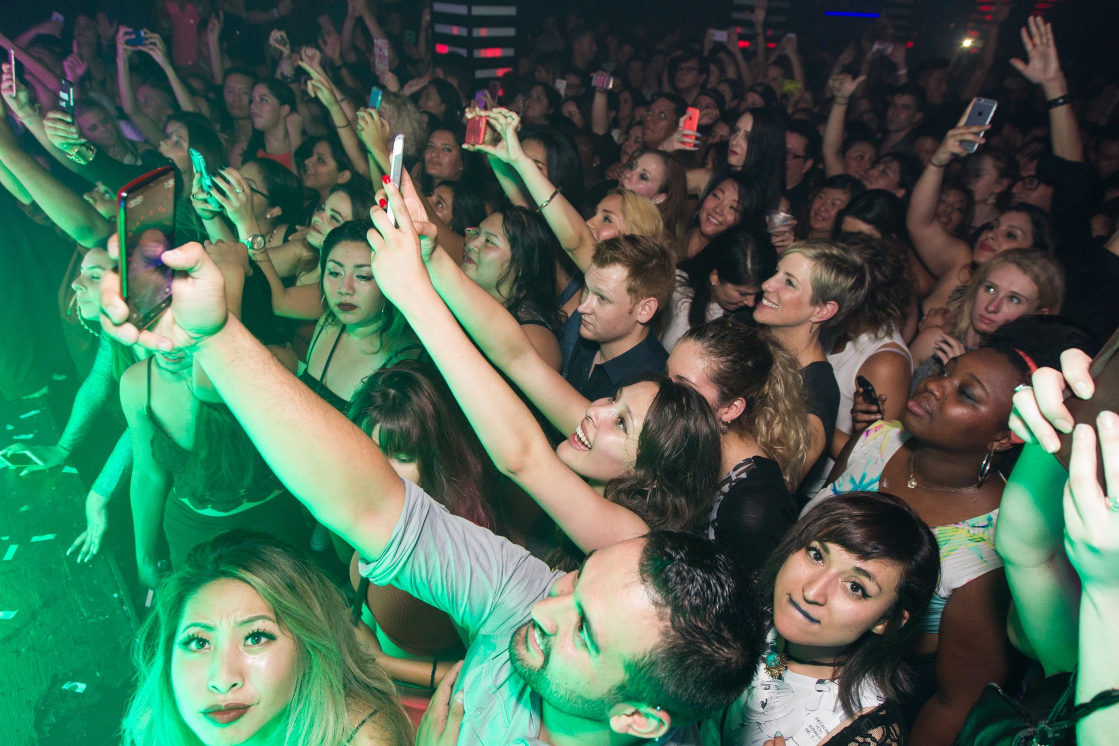 A crowd parties at a nightclub.