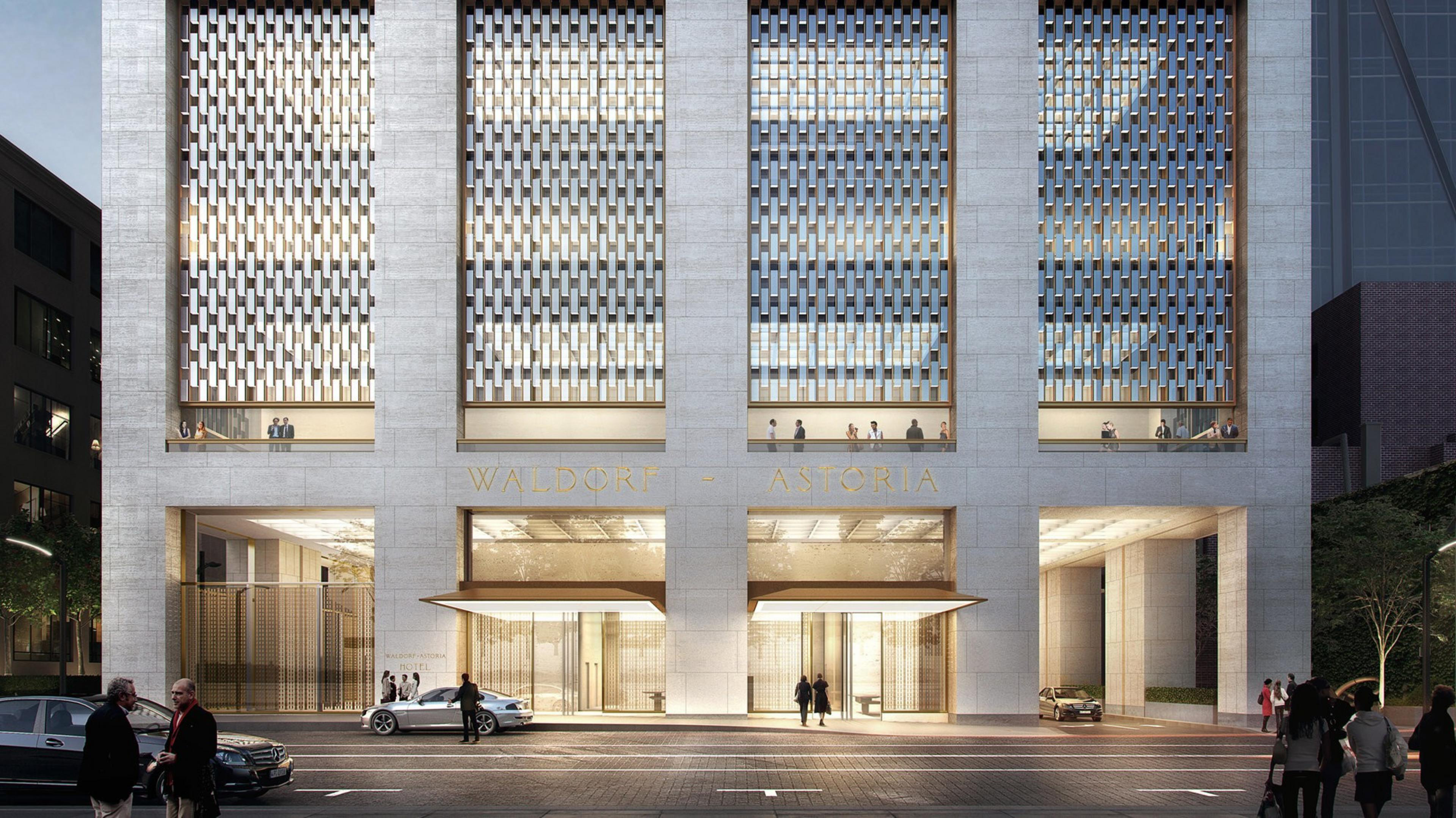 A modern building facade with &quot;WALDORF ASTORIA&quot; branding and pedestrians outside.