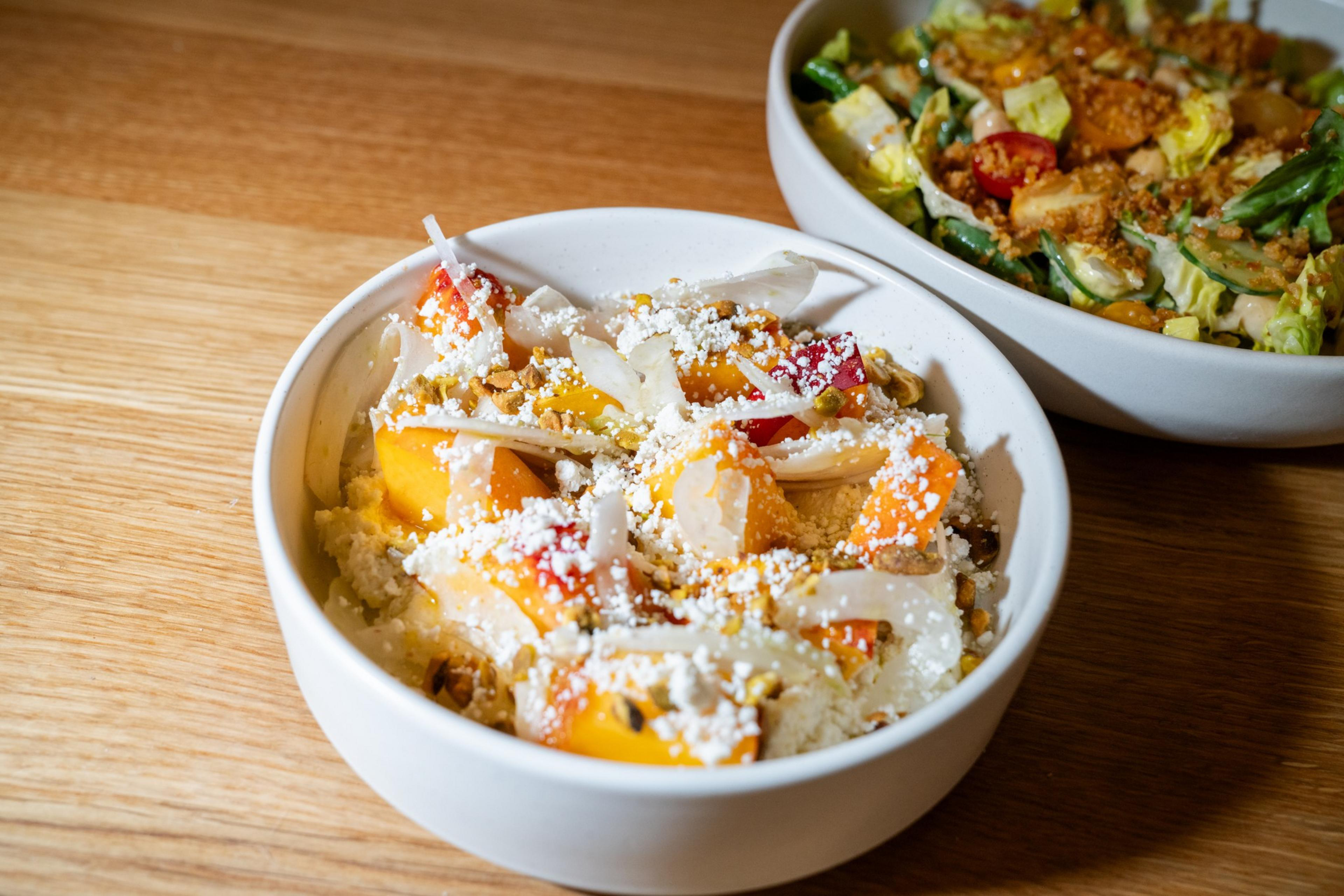A stone fruit and fennel dish is made with ricotta salata, pistachio and lemon oil.