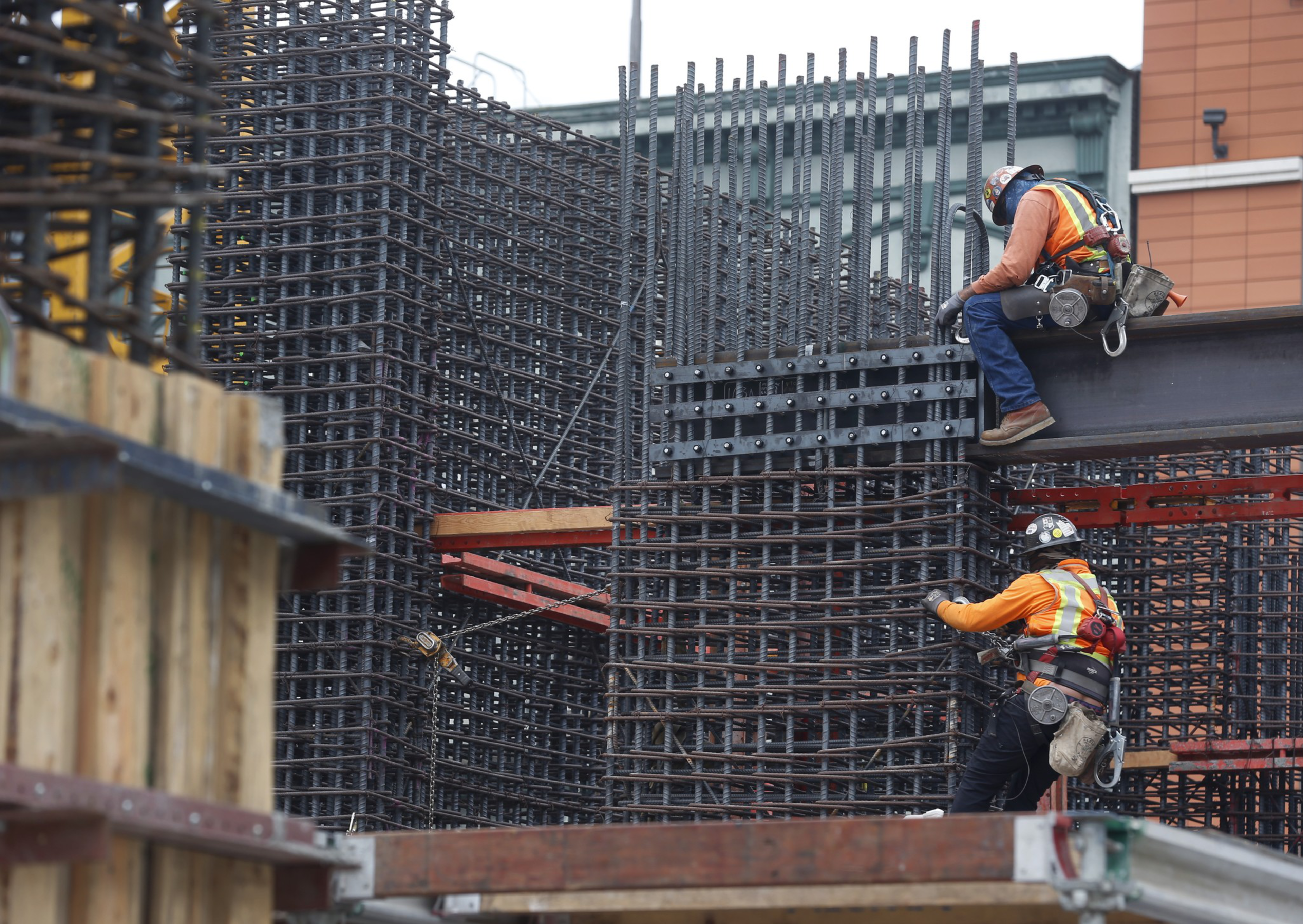 Construction workers work on a building project in San Francisco.