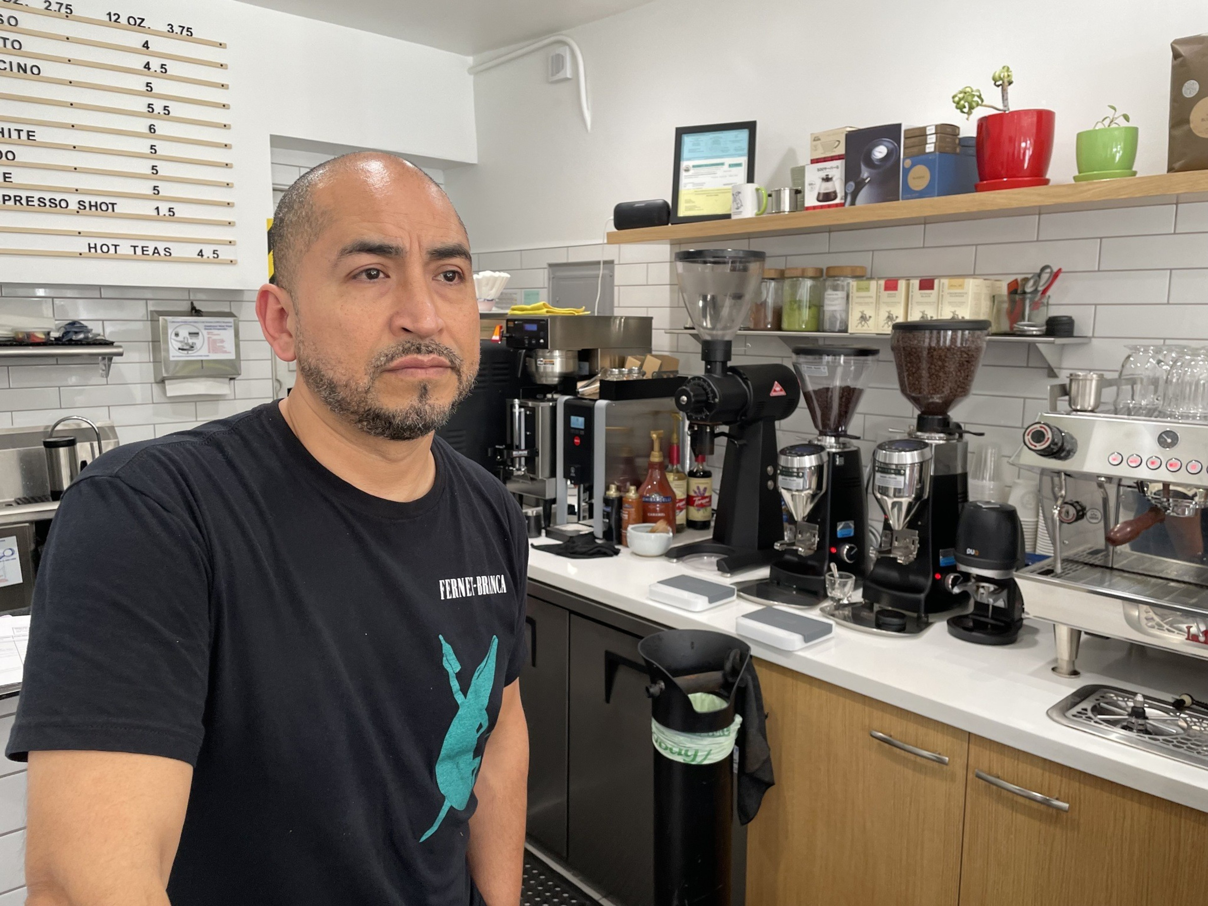 A man stands inside a cafe
