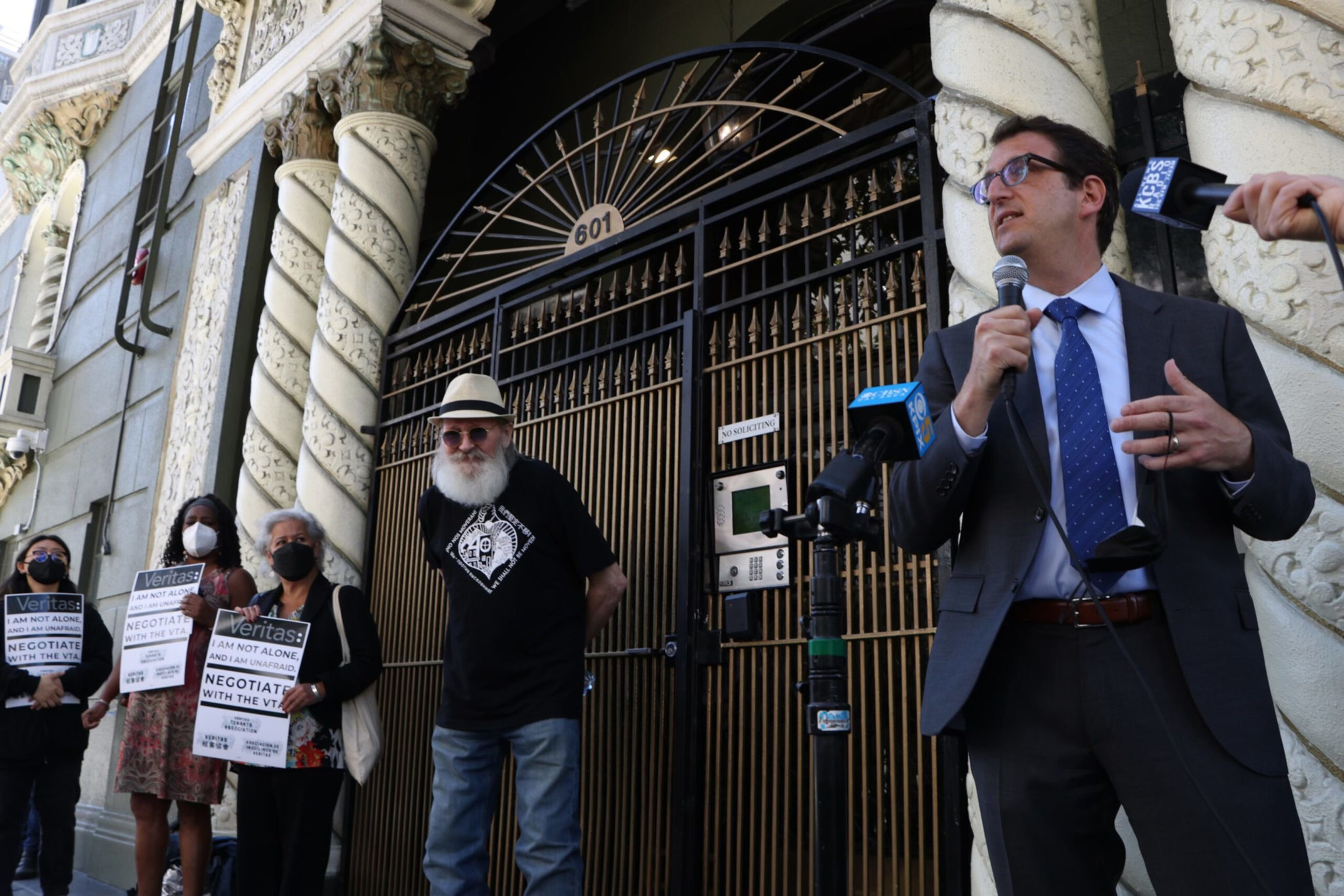 Supervisor Dean Preston speaks to reporters outside of an apartment building in San Francisco.
