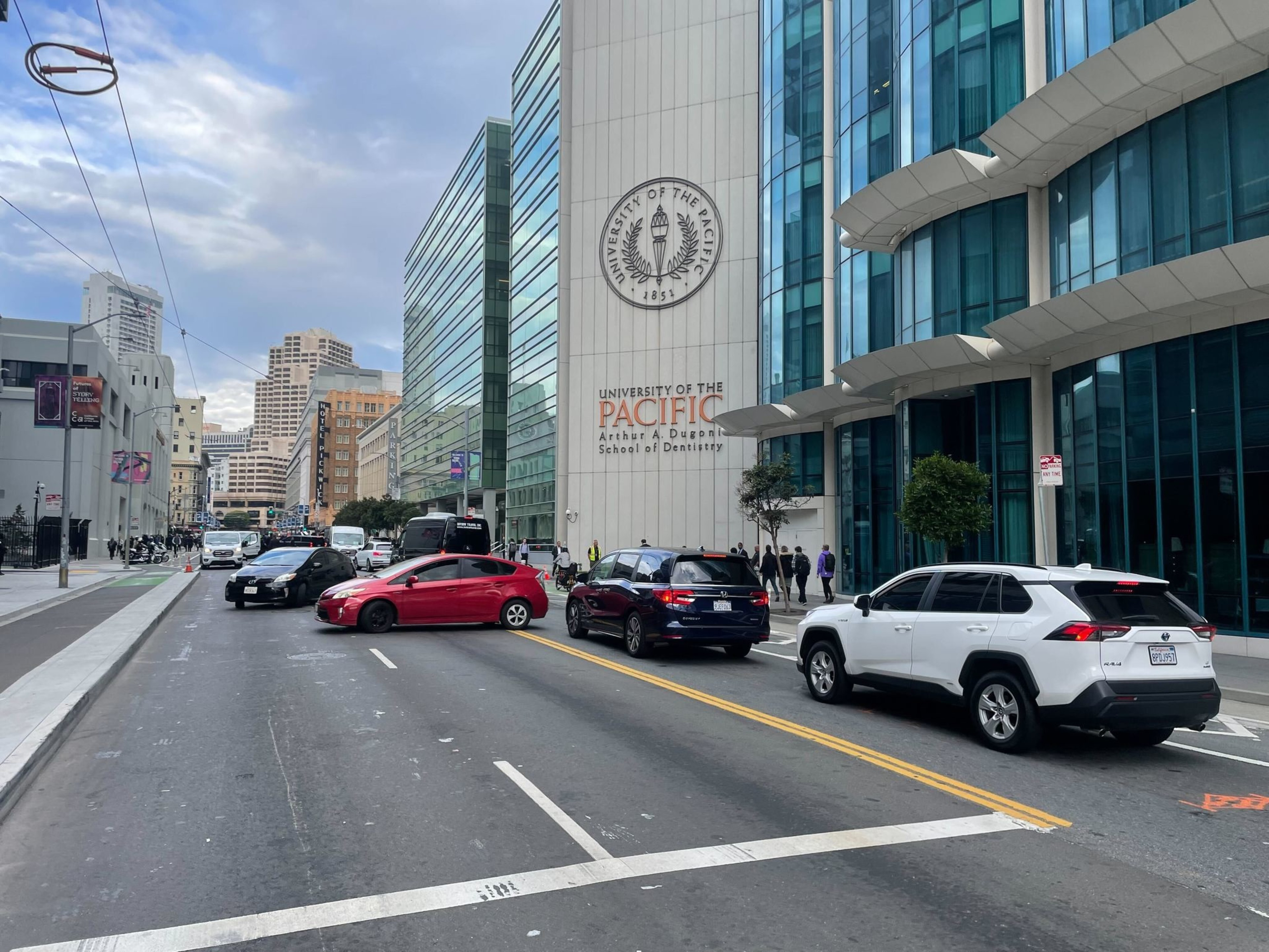 cars turn out of a lane of traffic to make a U-turn