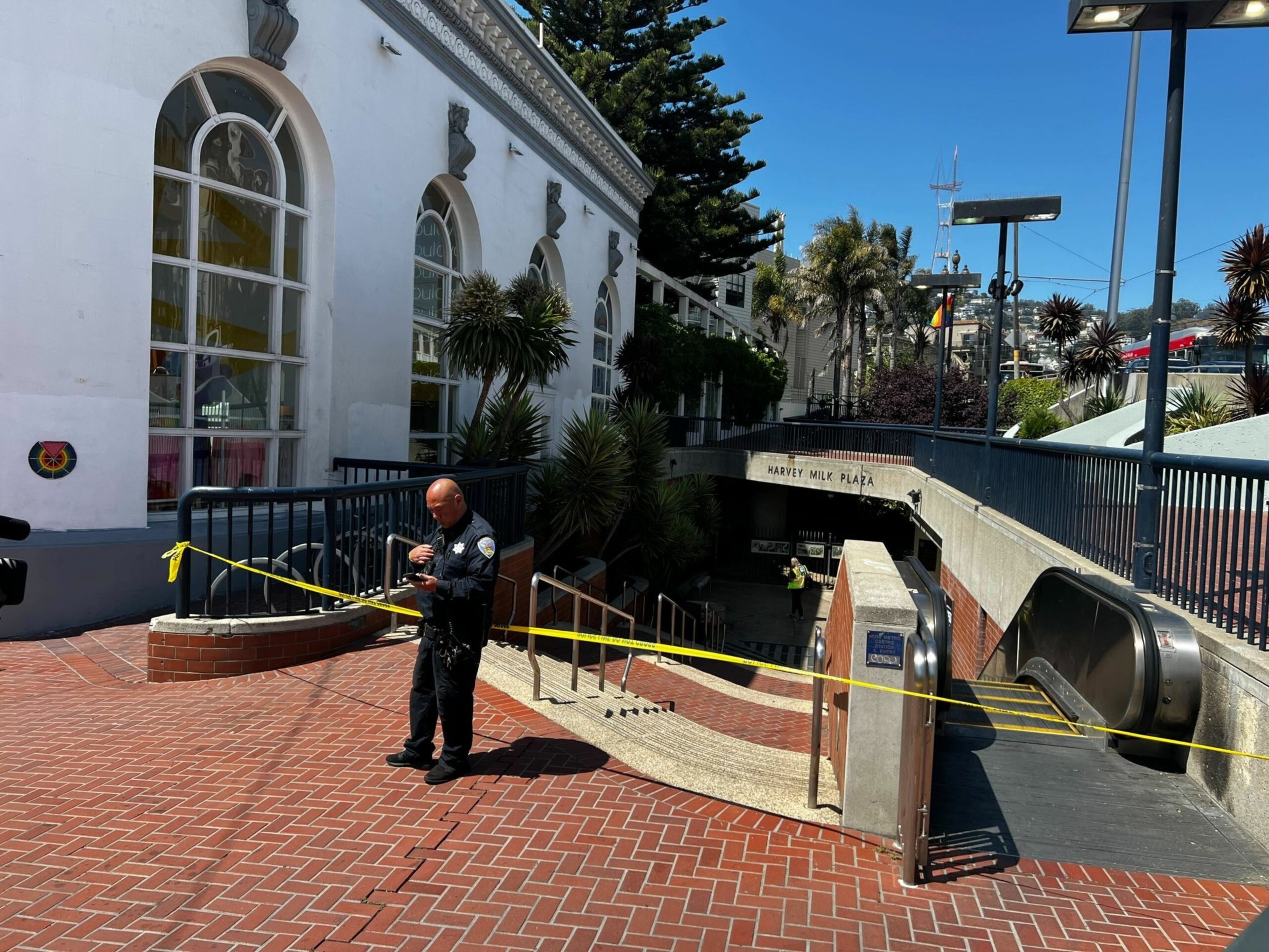 San Francisco Police Officers talk outside the Castro Muni station at Harvey Milk Plaza on Wednesday, June 22, 2022. Following a shooting on a Muni train, SFPD has confirmed that one victim has died and the second sustained non-life threatening injuries. | Camille Cohen/The Standard