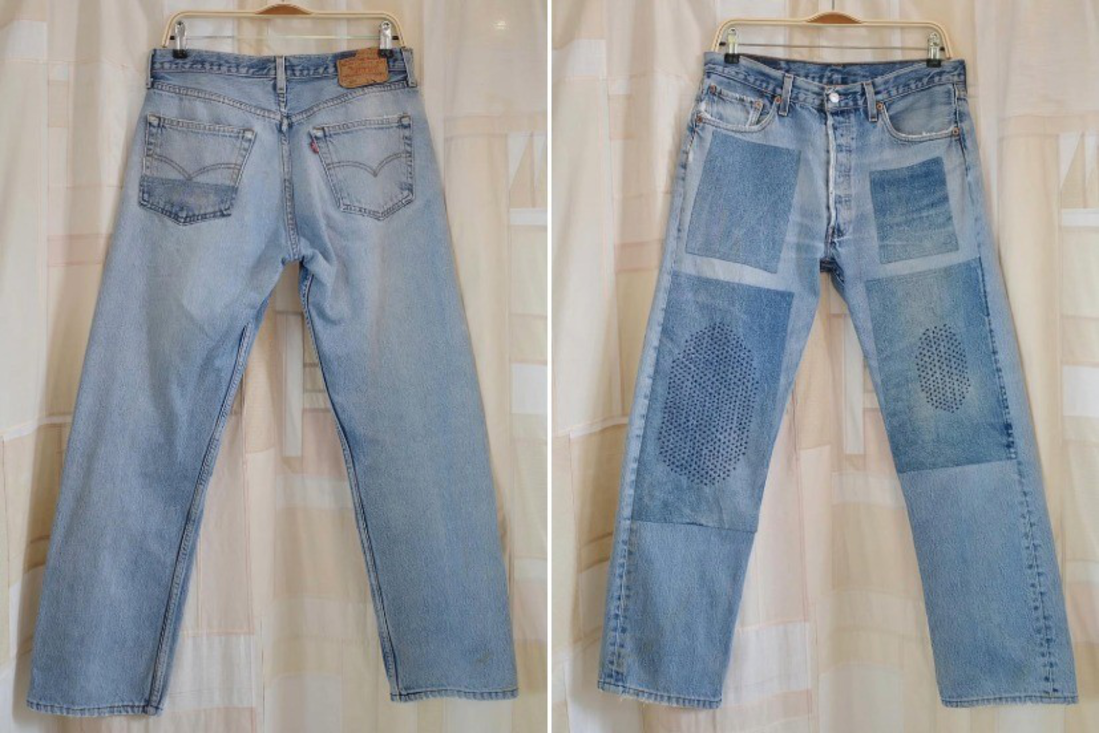 Light blue denim jeans hang on a hanger, shown front and back, with multiple stitched patches and visible repairs on the front but plain on the back.