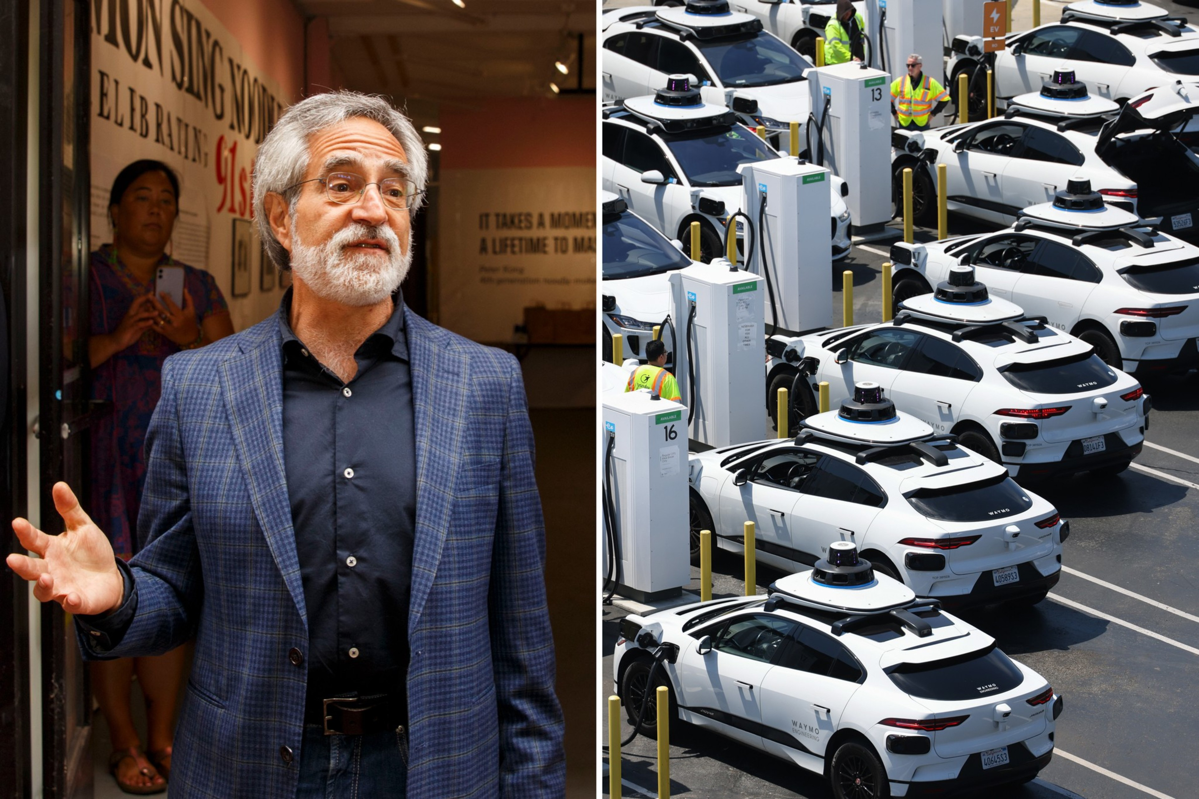 A man with gray hair and beard wearing a blue checked blazer speaks while multiple white autonomous cars charge at a station in a parking lot.