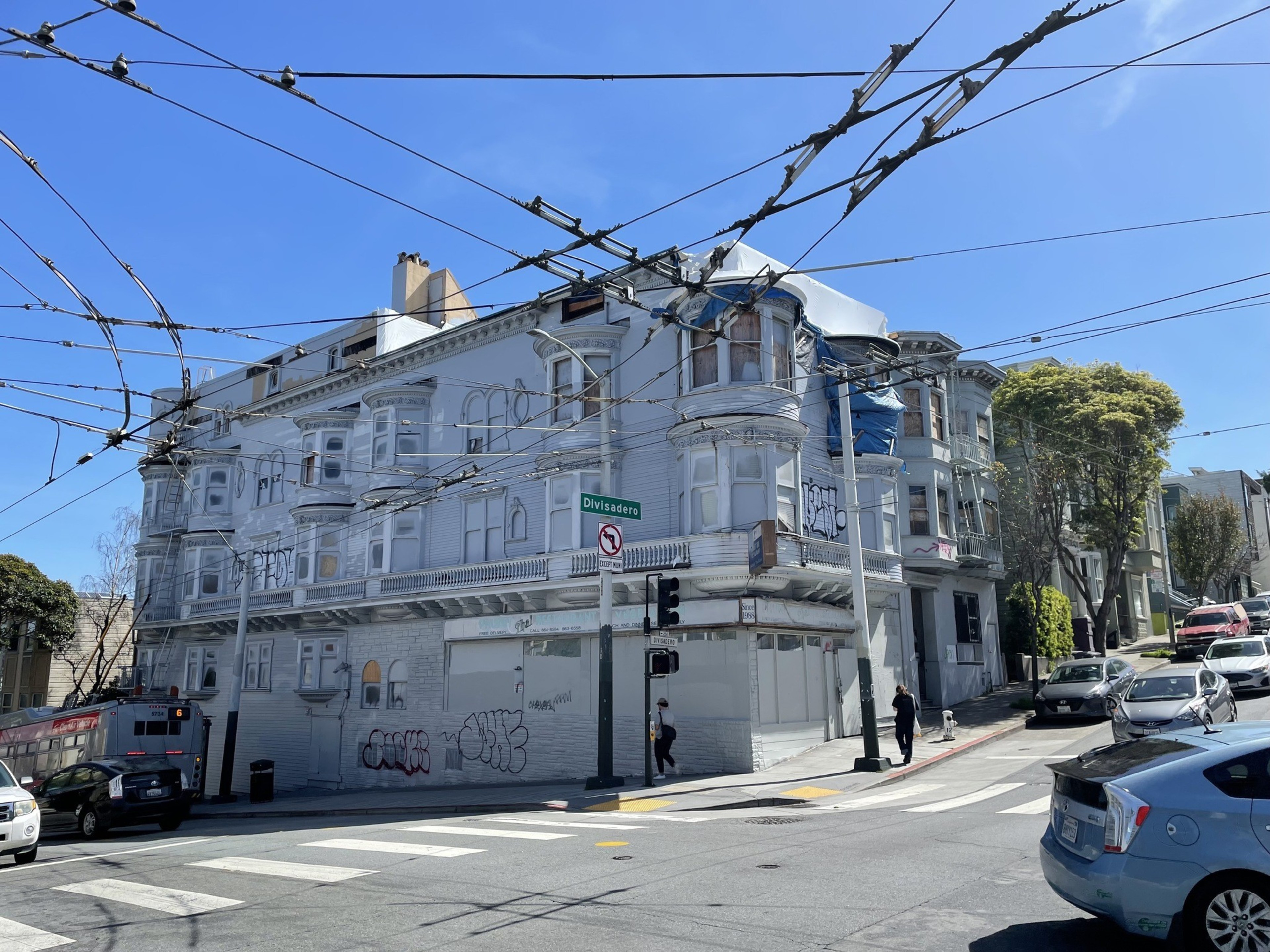 A vacant building overlooks an intersection.