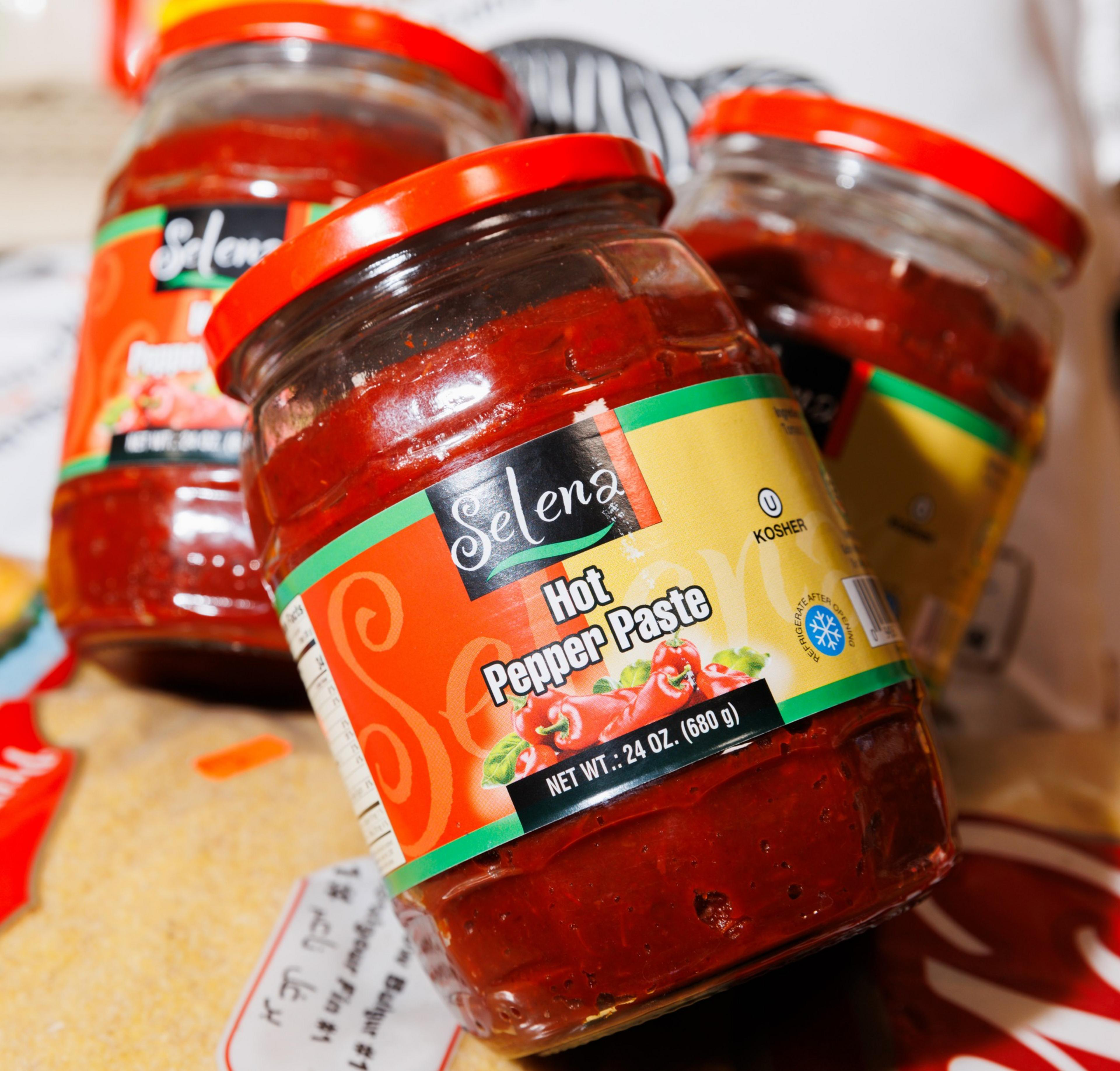 The image shows three jars of &quot;Selena Hot Pepper Paste&quot; with red contents, yellow and red labels, and red caps, indicating they are kosher and weigh 24 oz (680g).