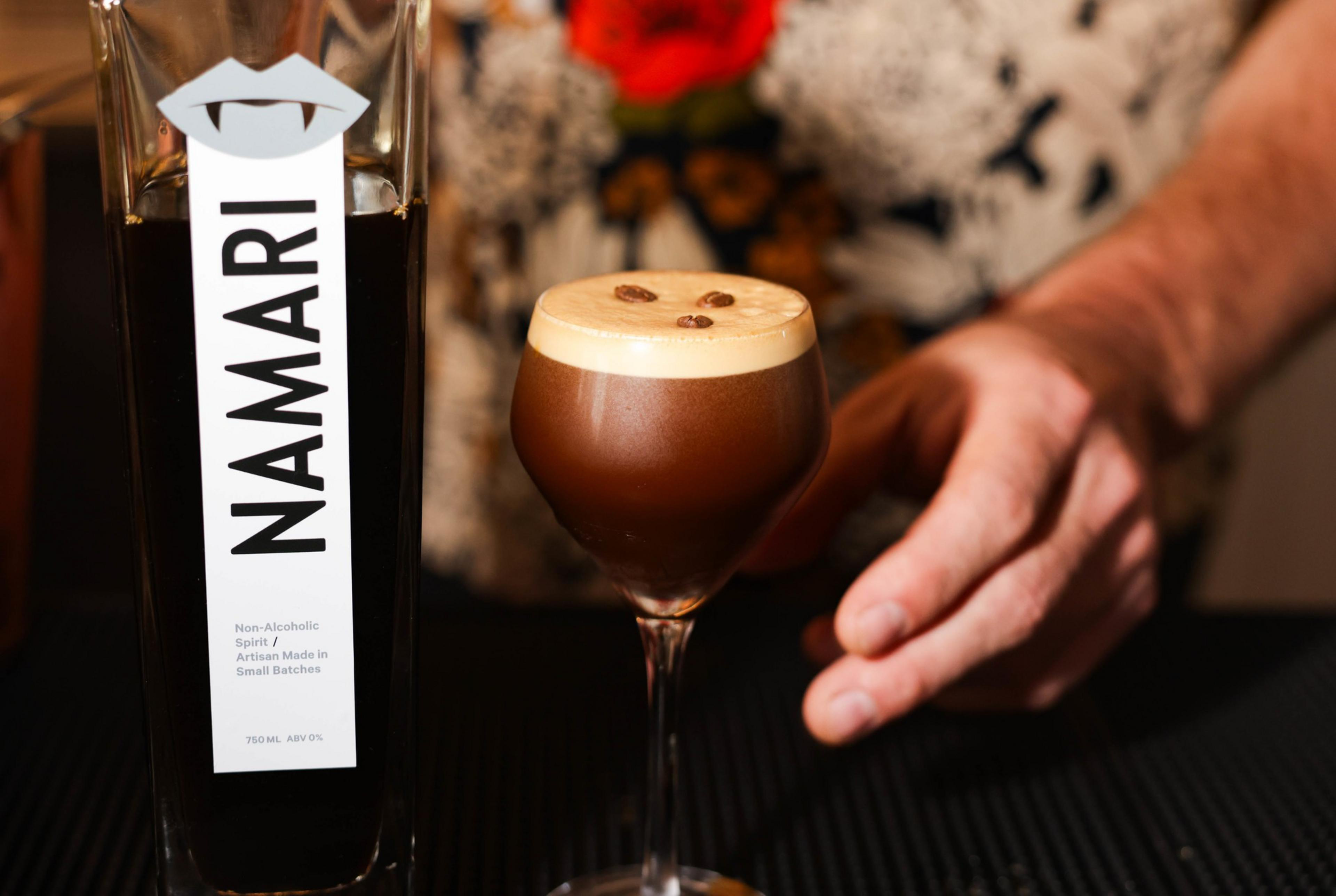 a white man's hand is seen next to a fancy cocktail