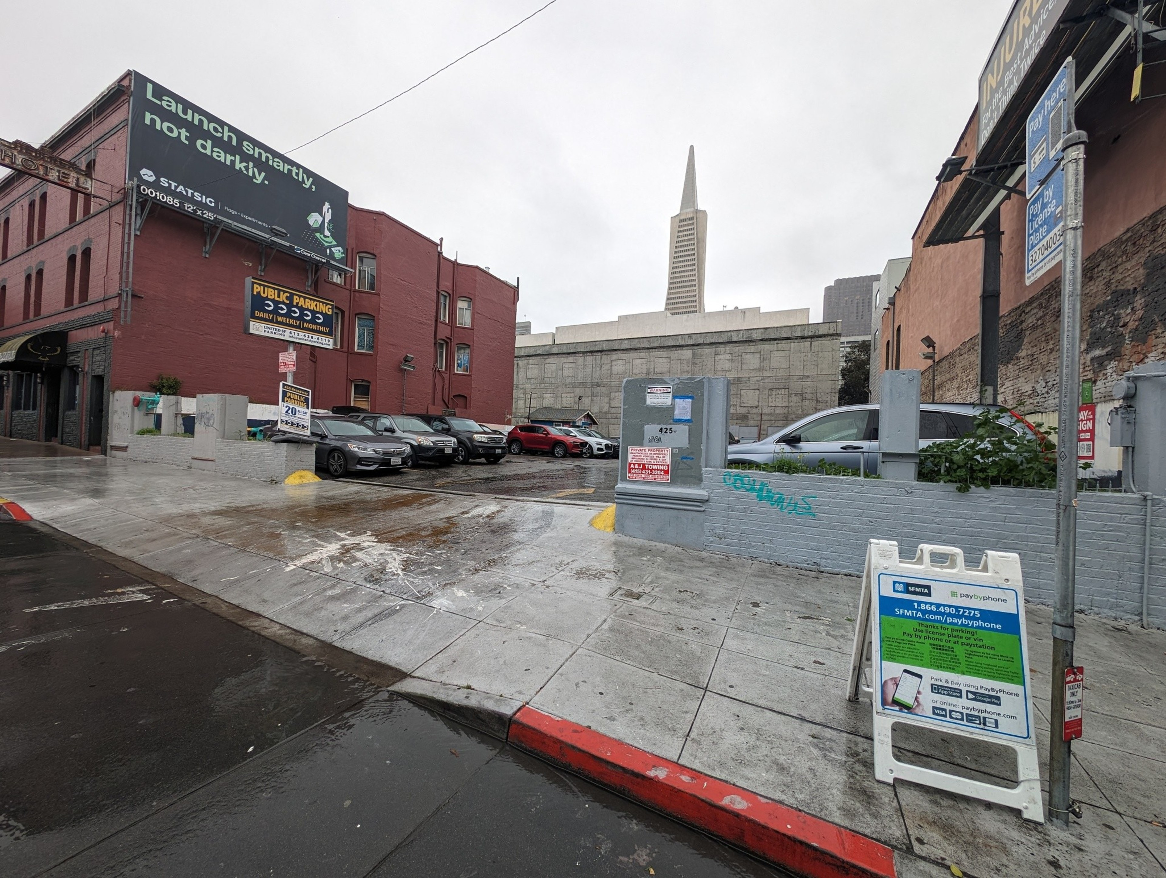 A driveway offers entry into a public off-street parking lot with daily, weekly and monthly rates.