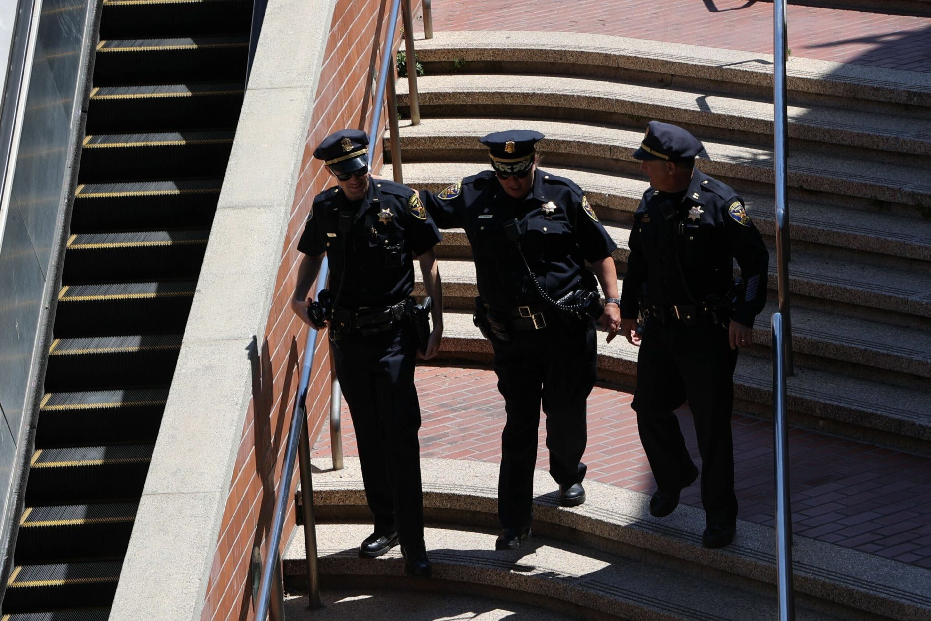 San Francisco Police Officers talk outside the Castro Muni station at Harvey Milk Plaza on Wednesday, June 22, 2022. Following a shooting on a Muni train, SFPD has confirmed that one victim has died and the second sustained non-life threatening injuries. | Camille Cohen/The Standard