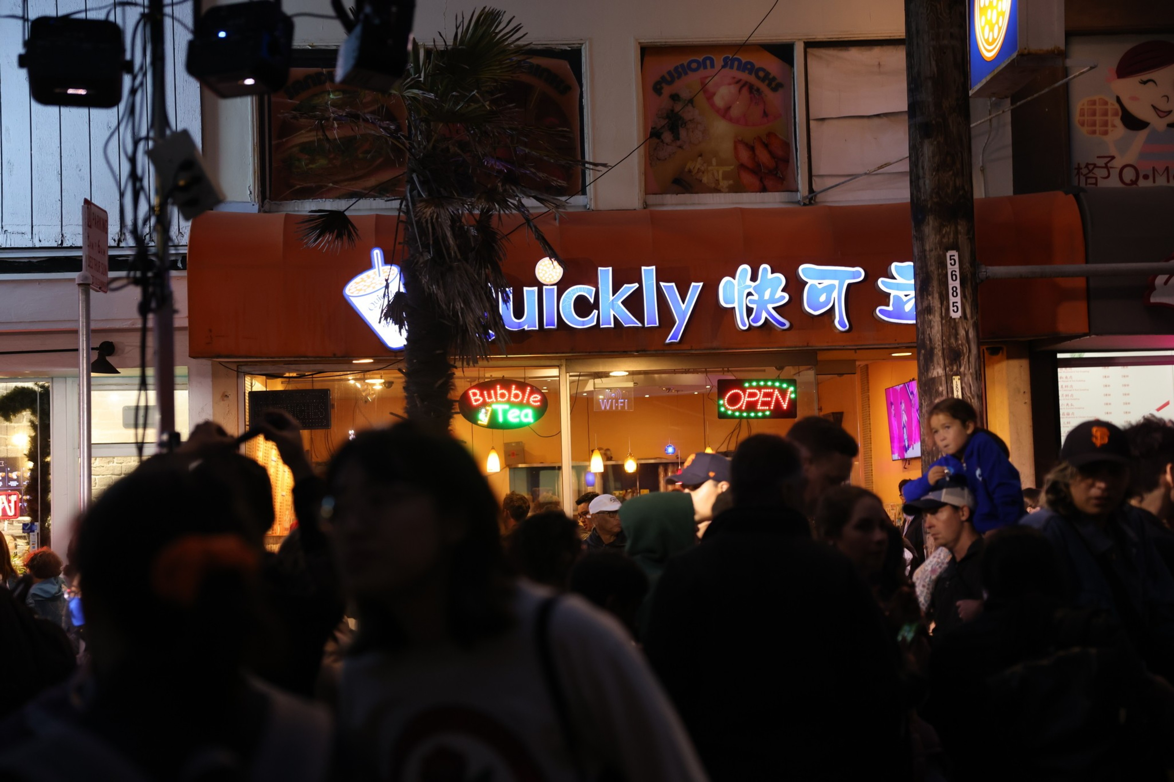 Thousands walk along Irving Street during the first-ever Sunset Night Market.
