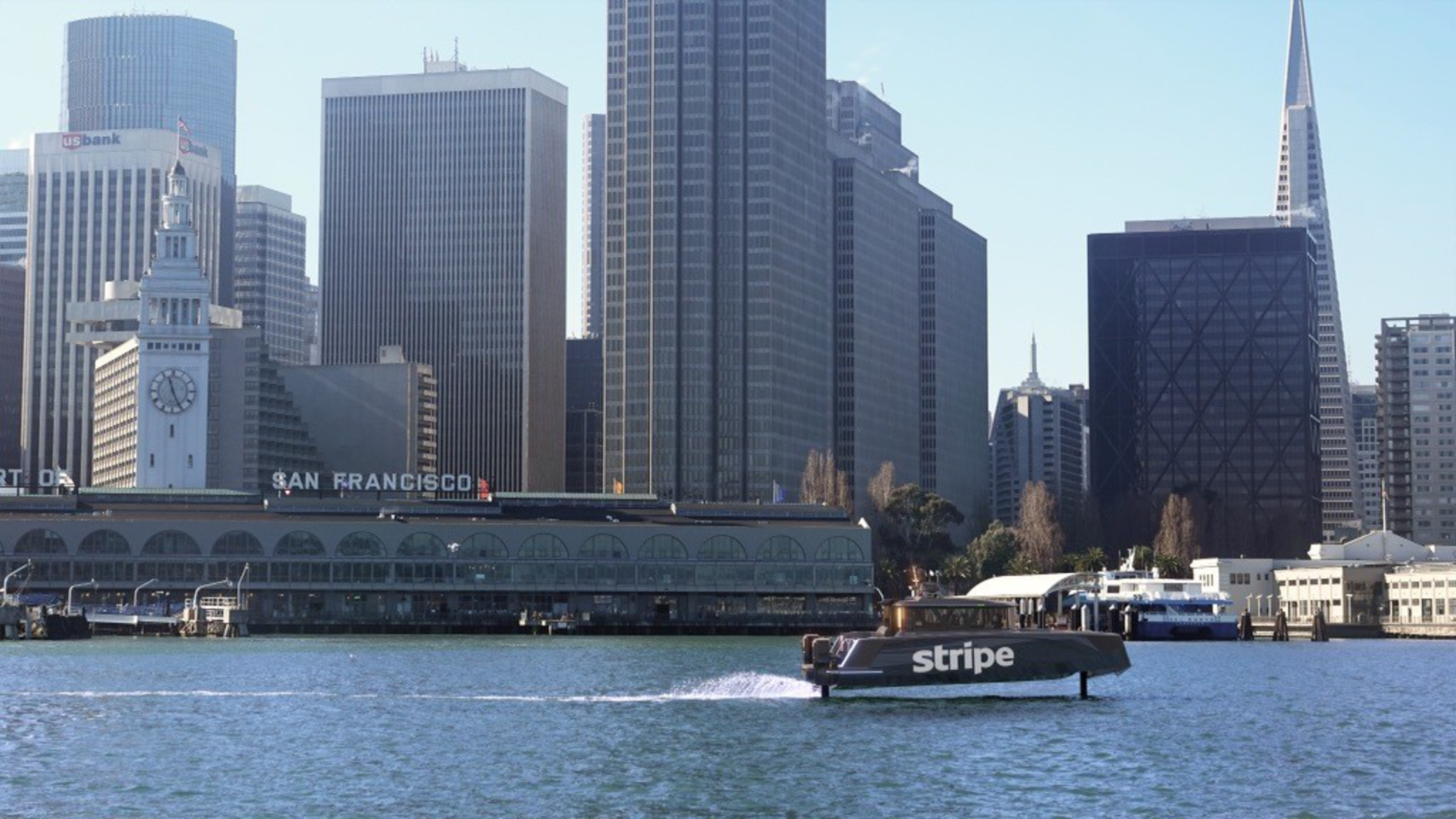a long shot of a Stripe-branded ferry in front of the San Francisco skyline.