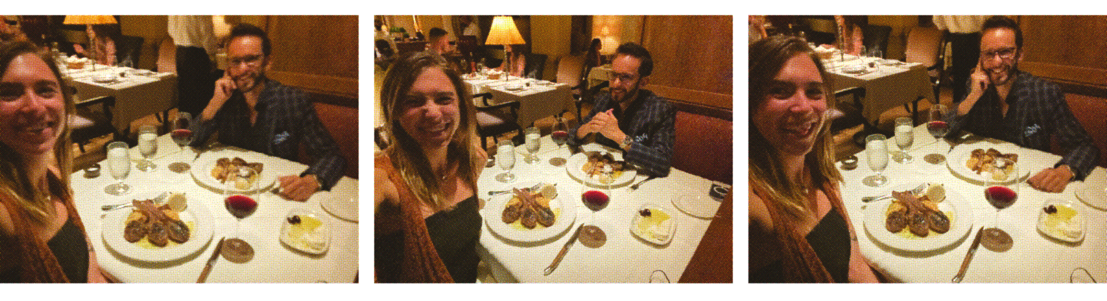 A man and a woman smiling at the camera while sitting at a restaurant table with plates of food, wine, and glasses.