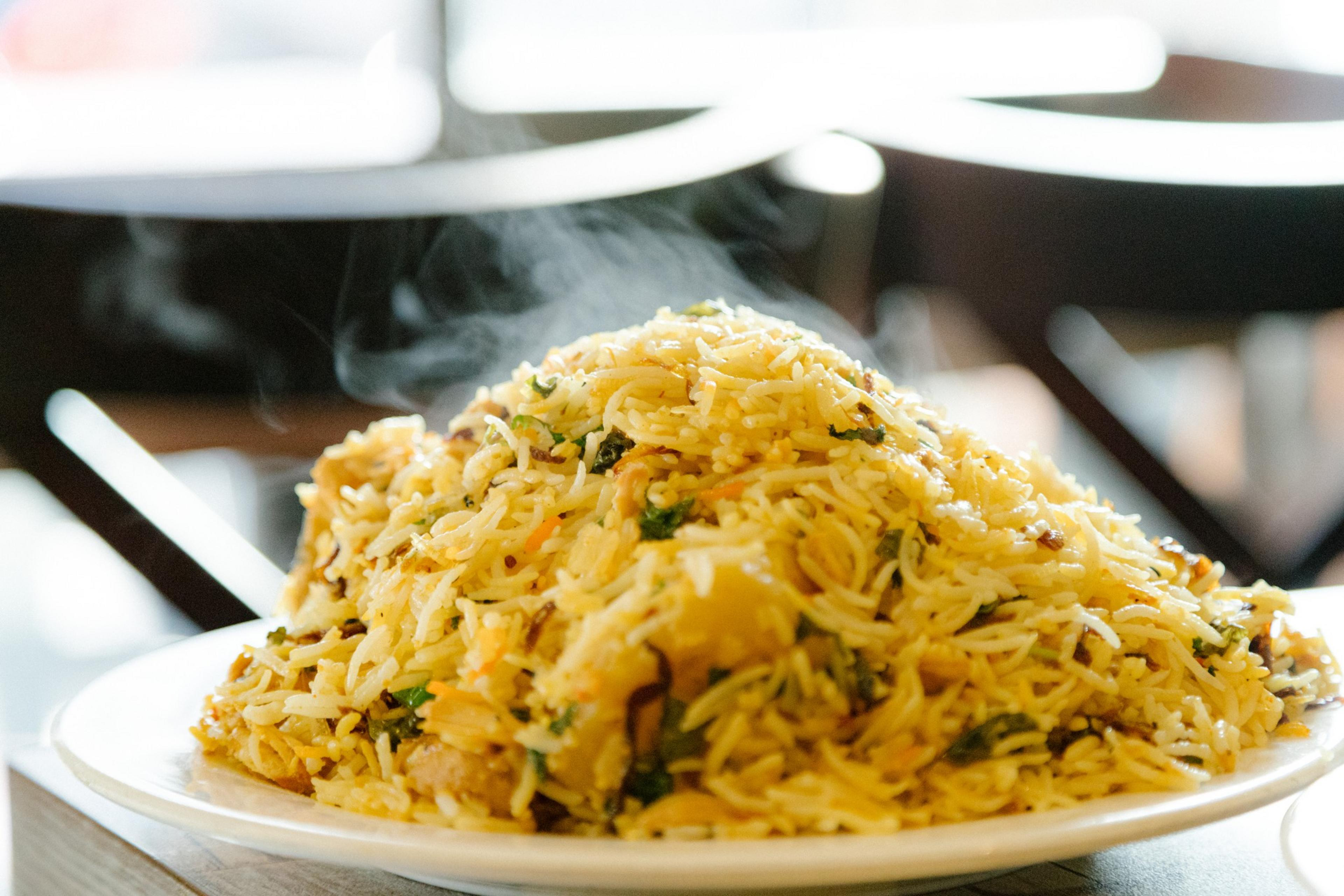 Chicken biryani steams on a plate at Pakwan restaurant in San Francisco.