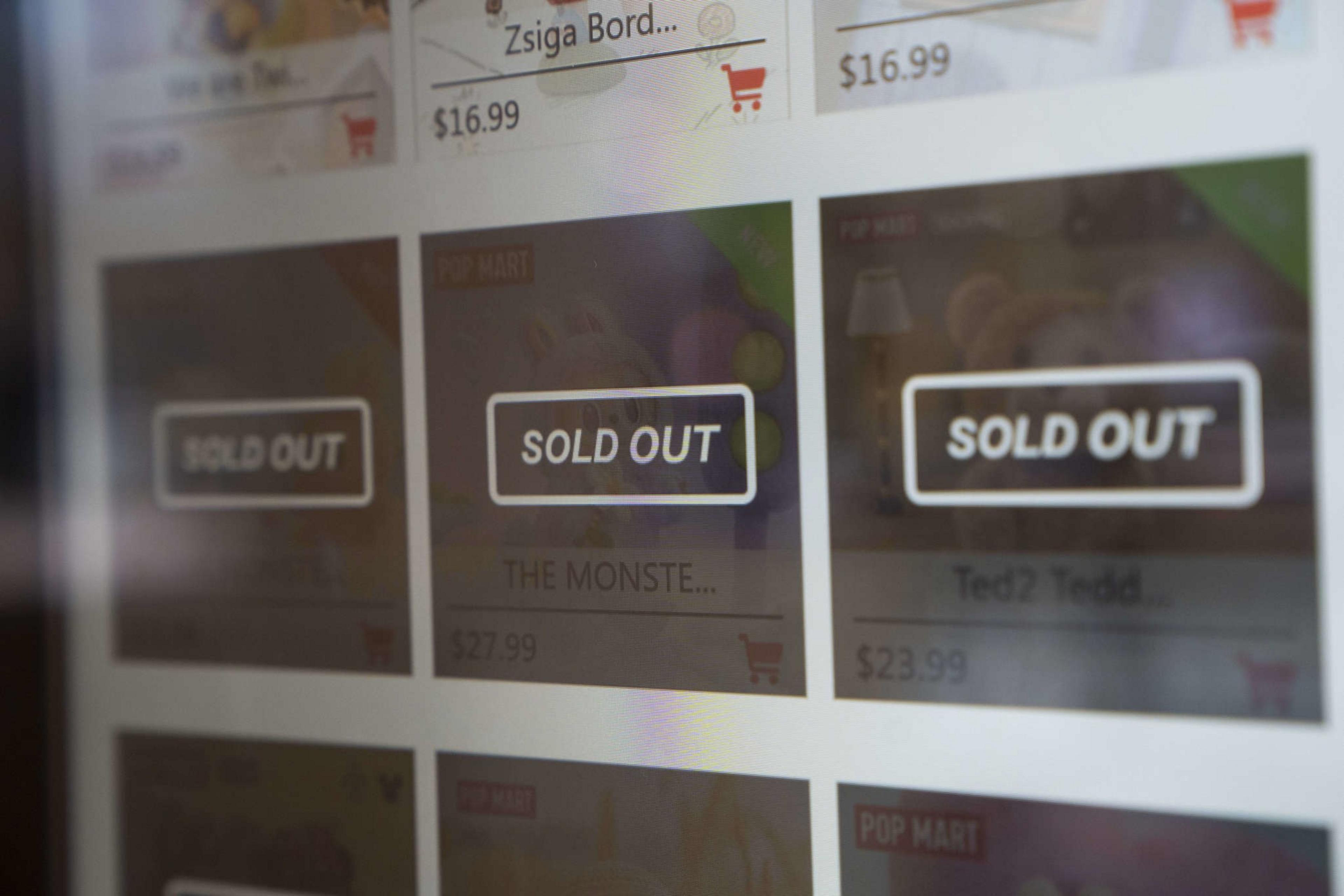 The image shows a webpage with several products listed, each marked &quot;Sold Out.&quot; Prices are visible, and there's a shopping cart icon next to each item.