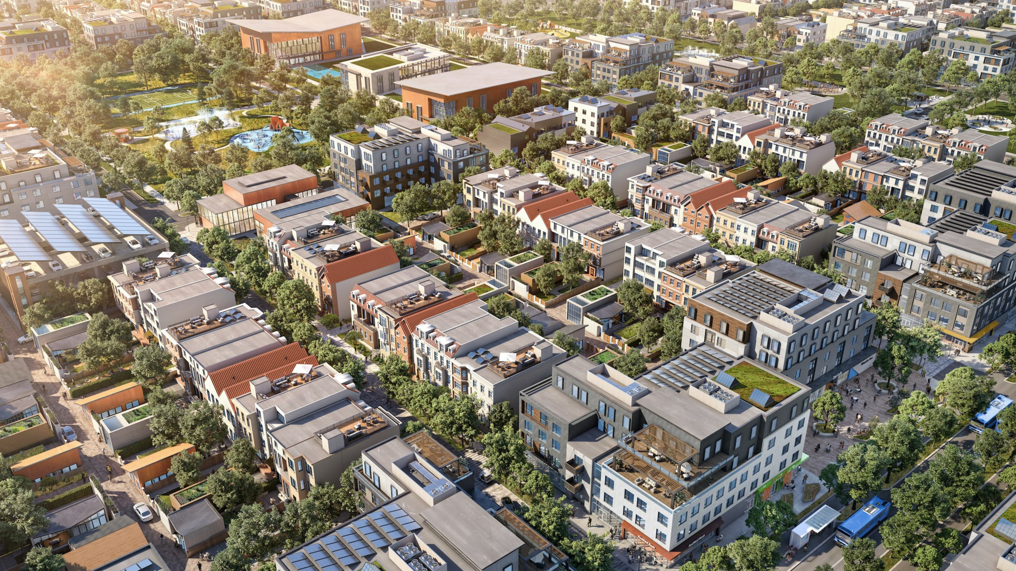 Aerial view of a dense urban area with various modern buildings and green spaces.