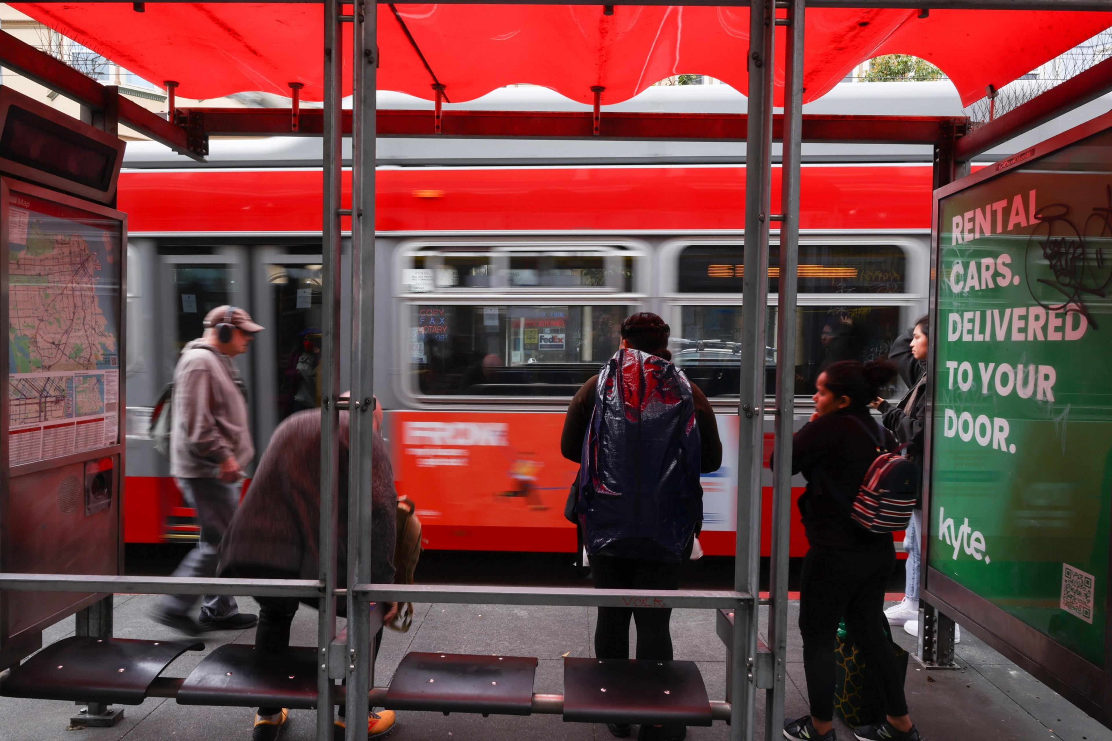 Riders waiting for a bus.