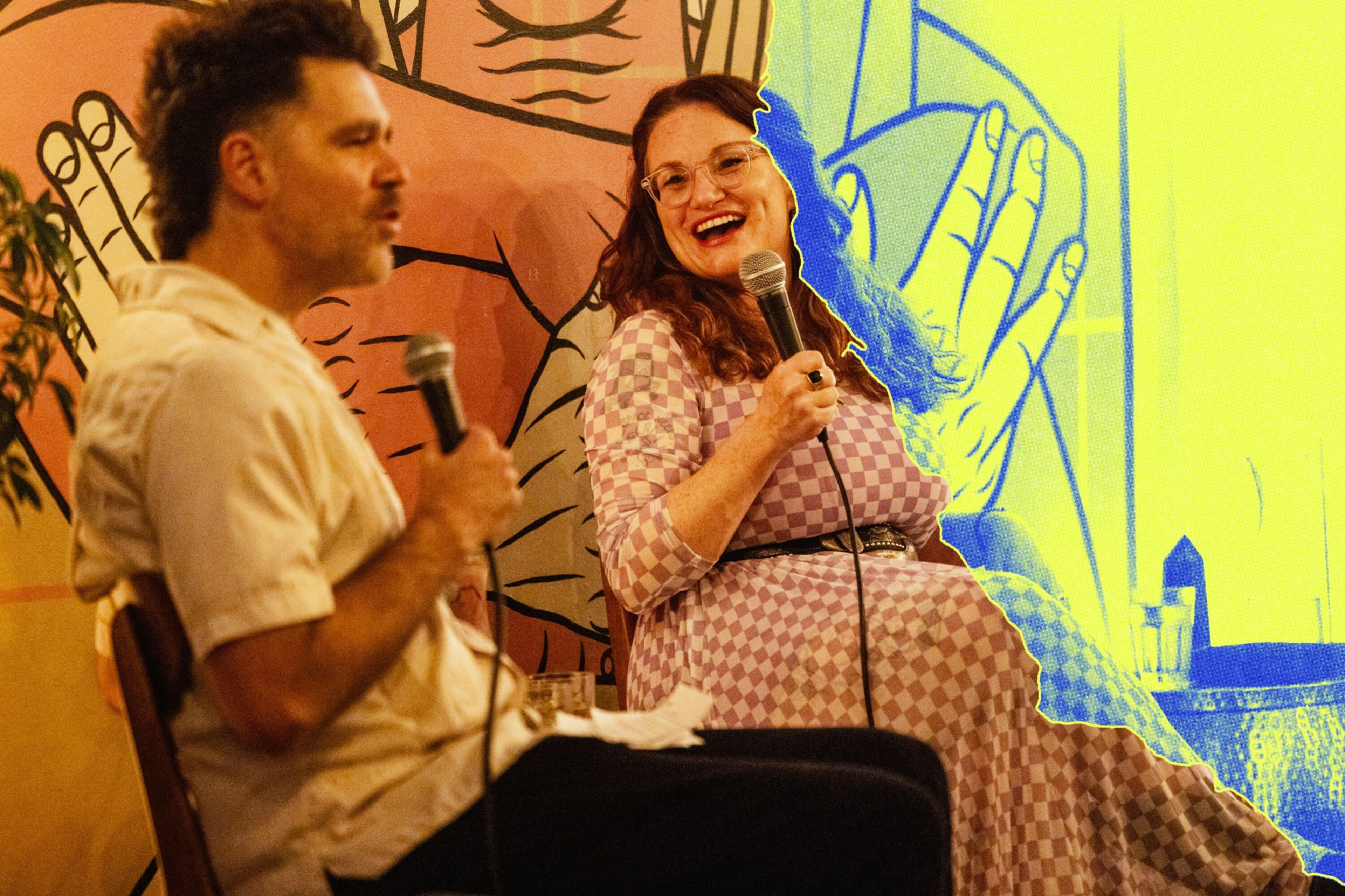 A man and a woman sit holding microphones; the woman smiles and wears glasses and a checkered dress, with colorful artistic backgrounds behind them.