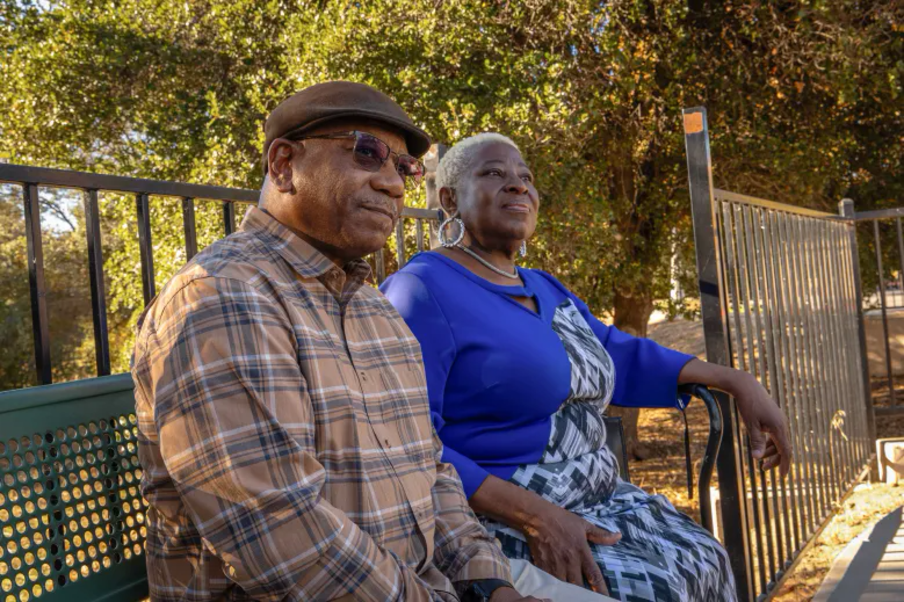 Man and woman sit on park bench