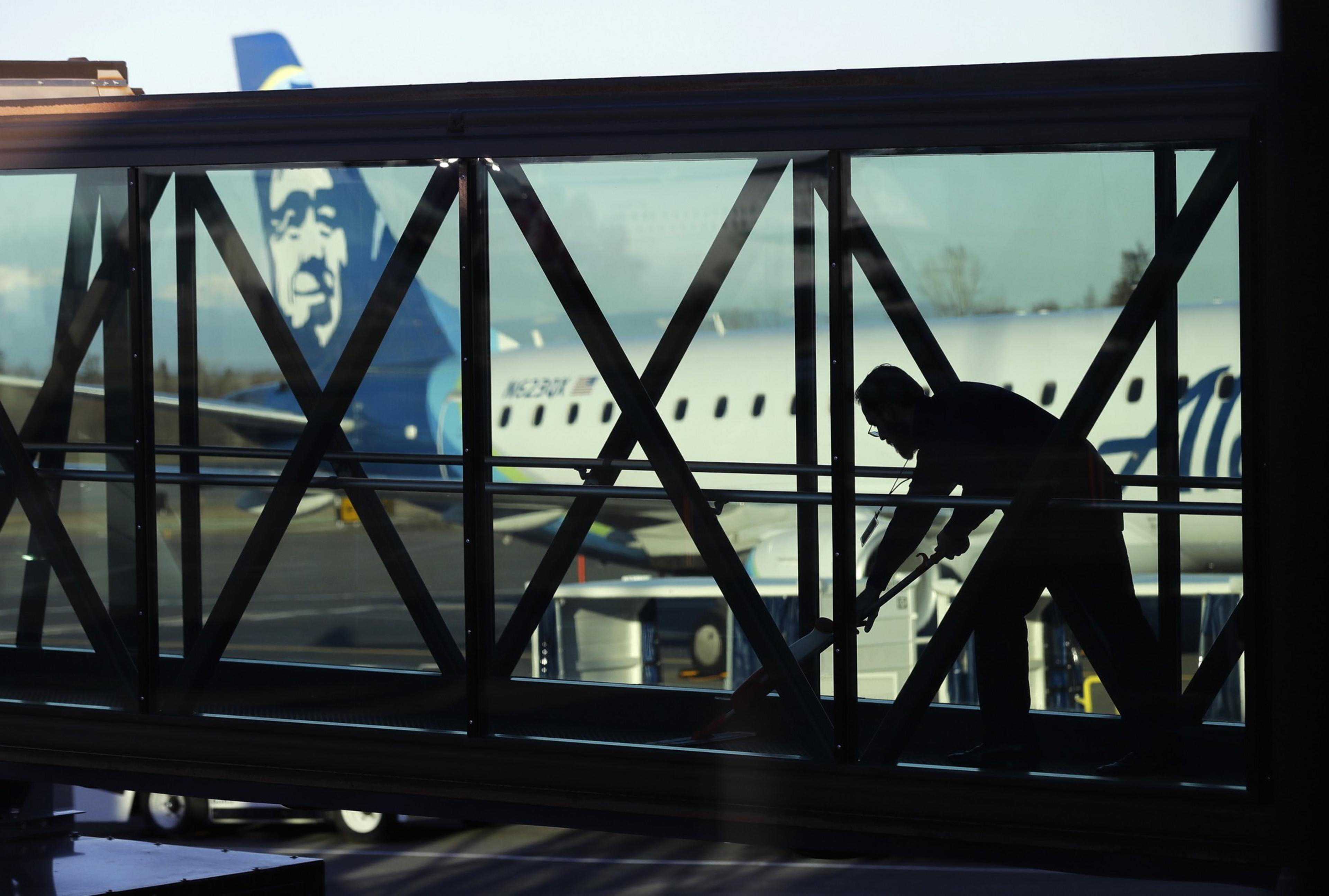 A white plane with blue writing sits on an runway.