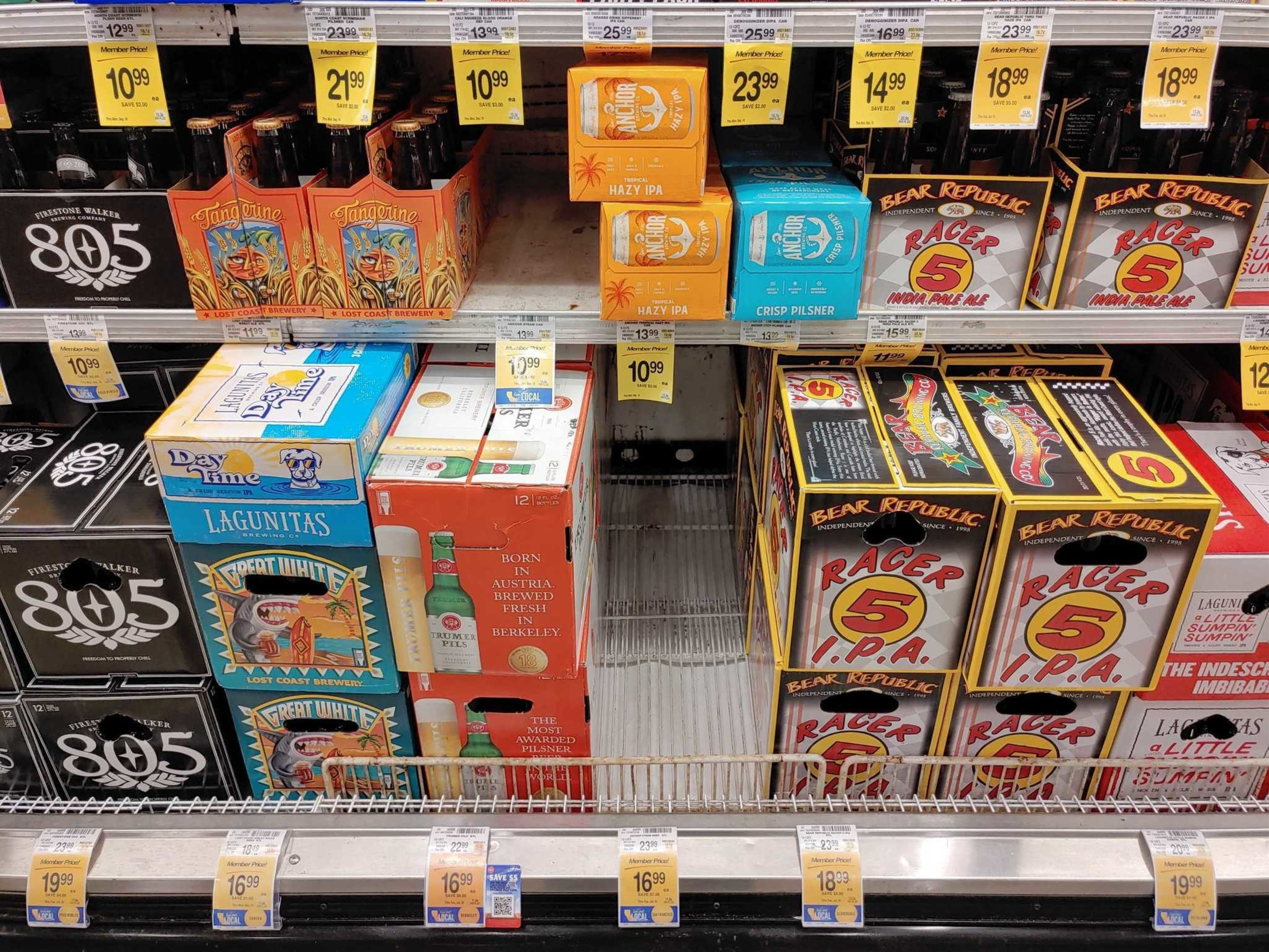 Shelves display various packaged craft beers including Firestone Walker 805, Lost Coast Tangarine, Lagunitas, Anchor Hazy IPA, and Bear Republic Racer 5 IPA.