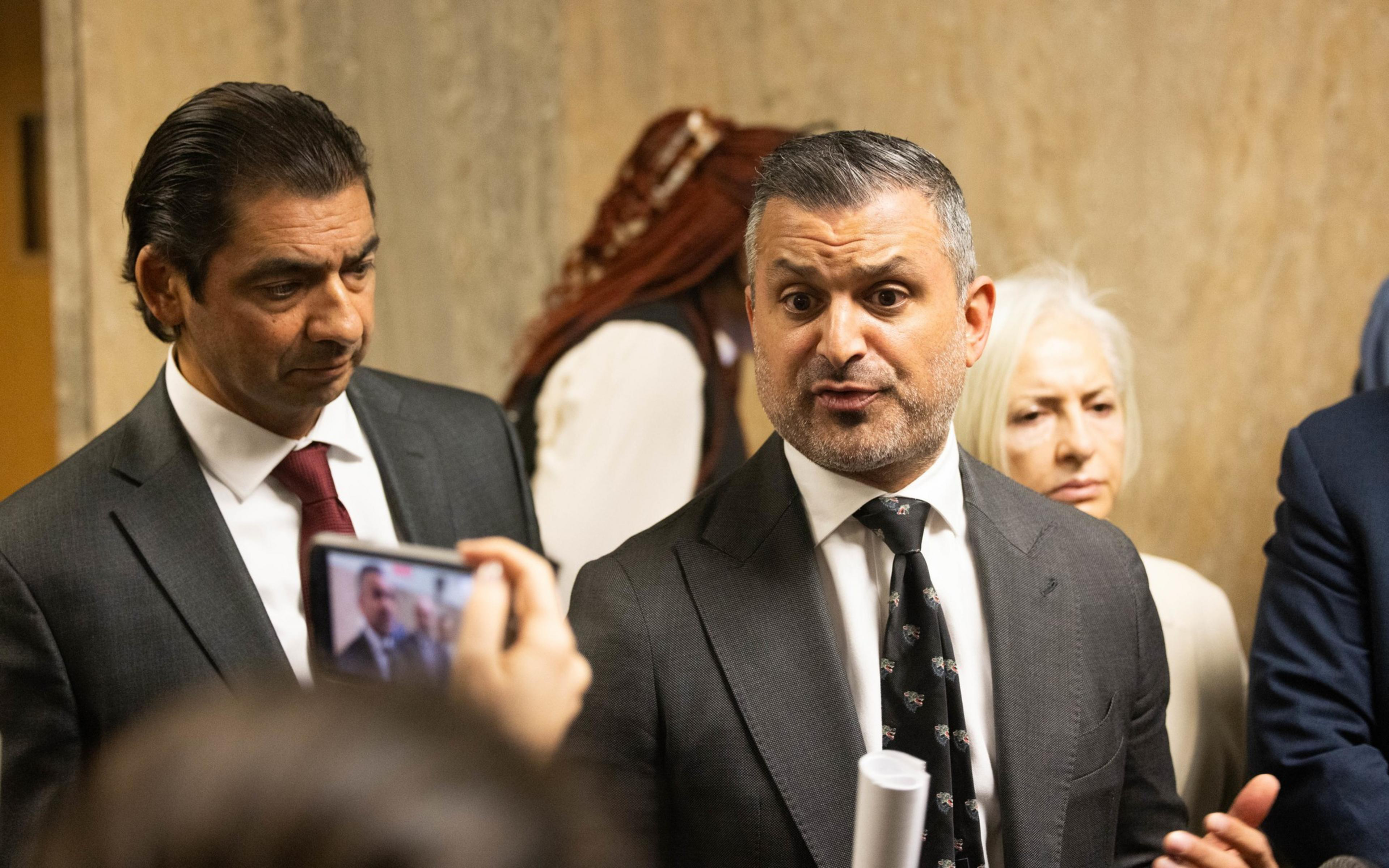A press conference with lawyers speaking to the media.
