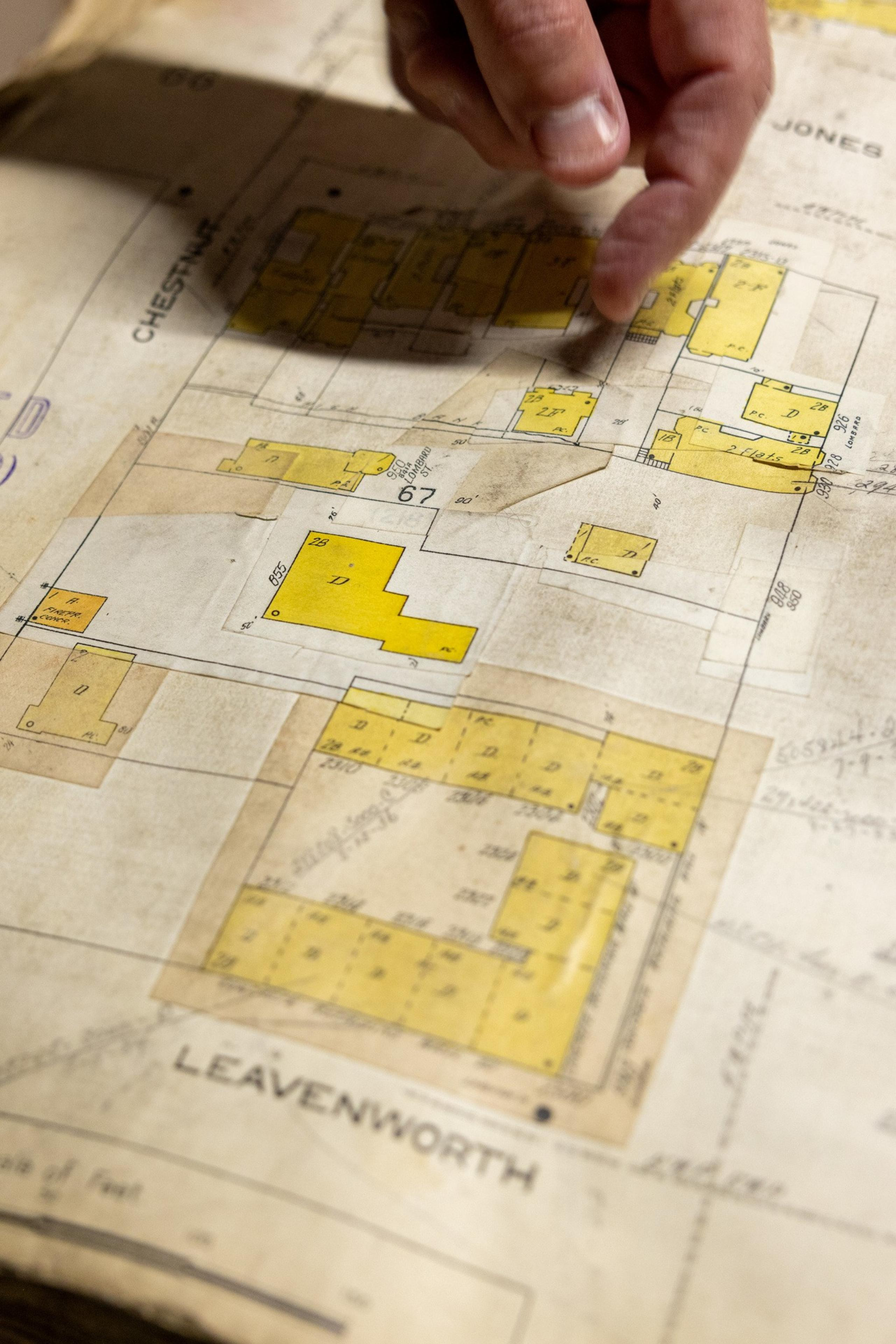 Woody LaBounty, president and CEO of San Francisco Heritage, points out 950 Lombard St. on an old insurance map.