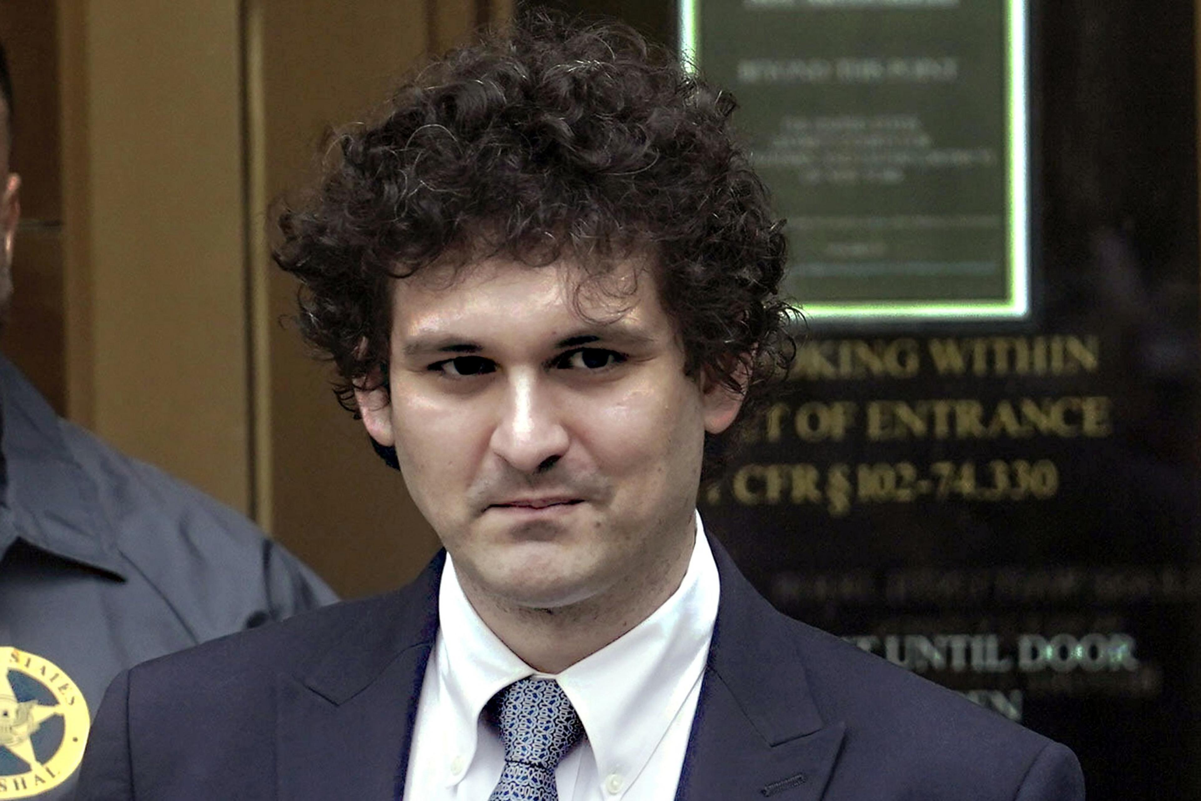 A man smirks in a court room