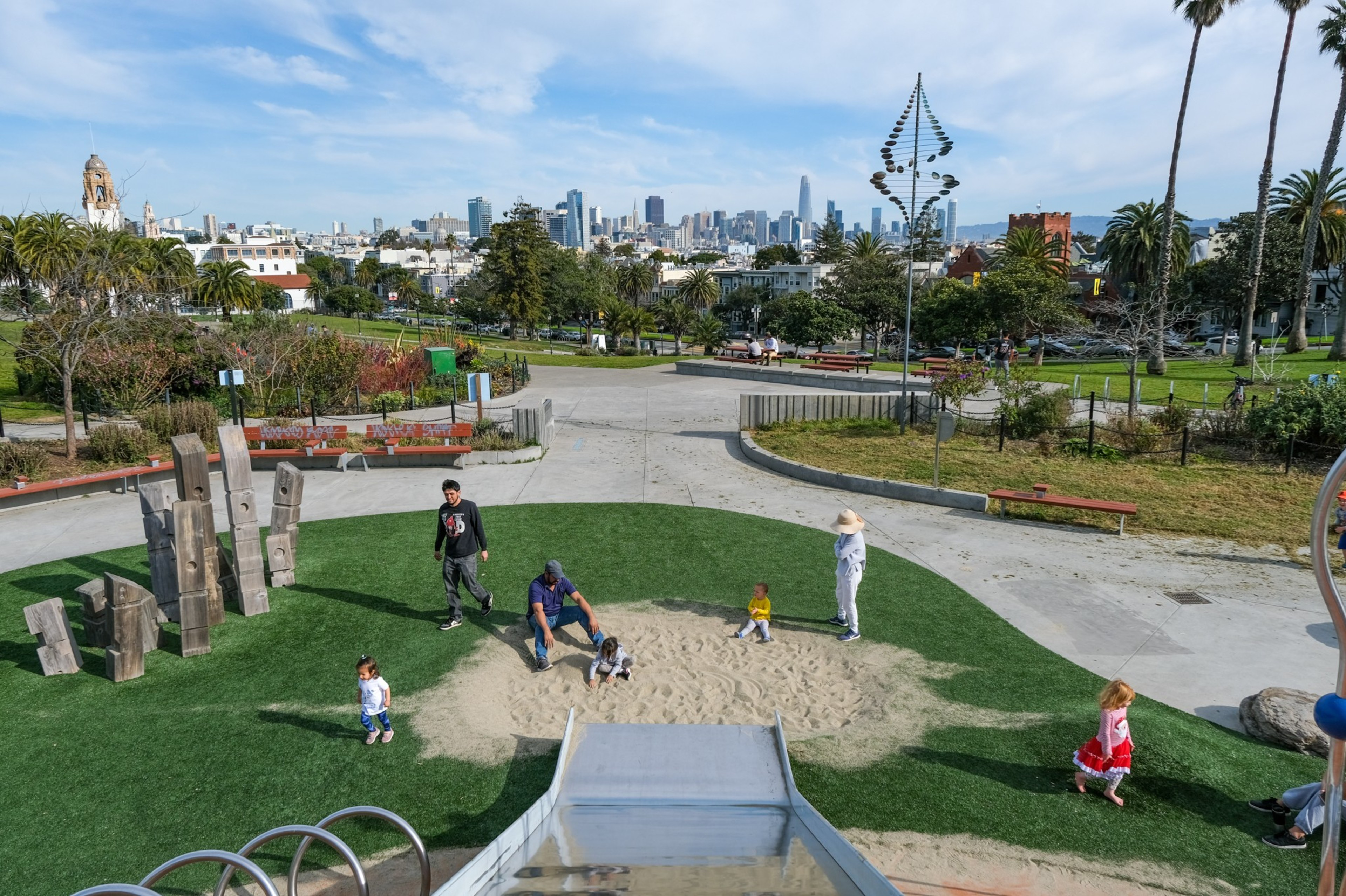 Kids play near a slide at a playground.