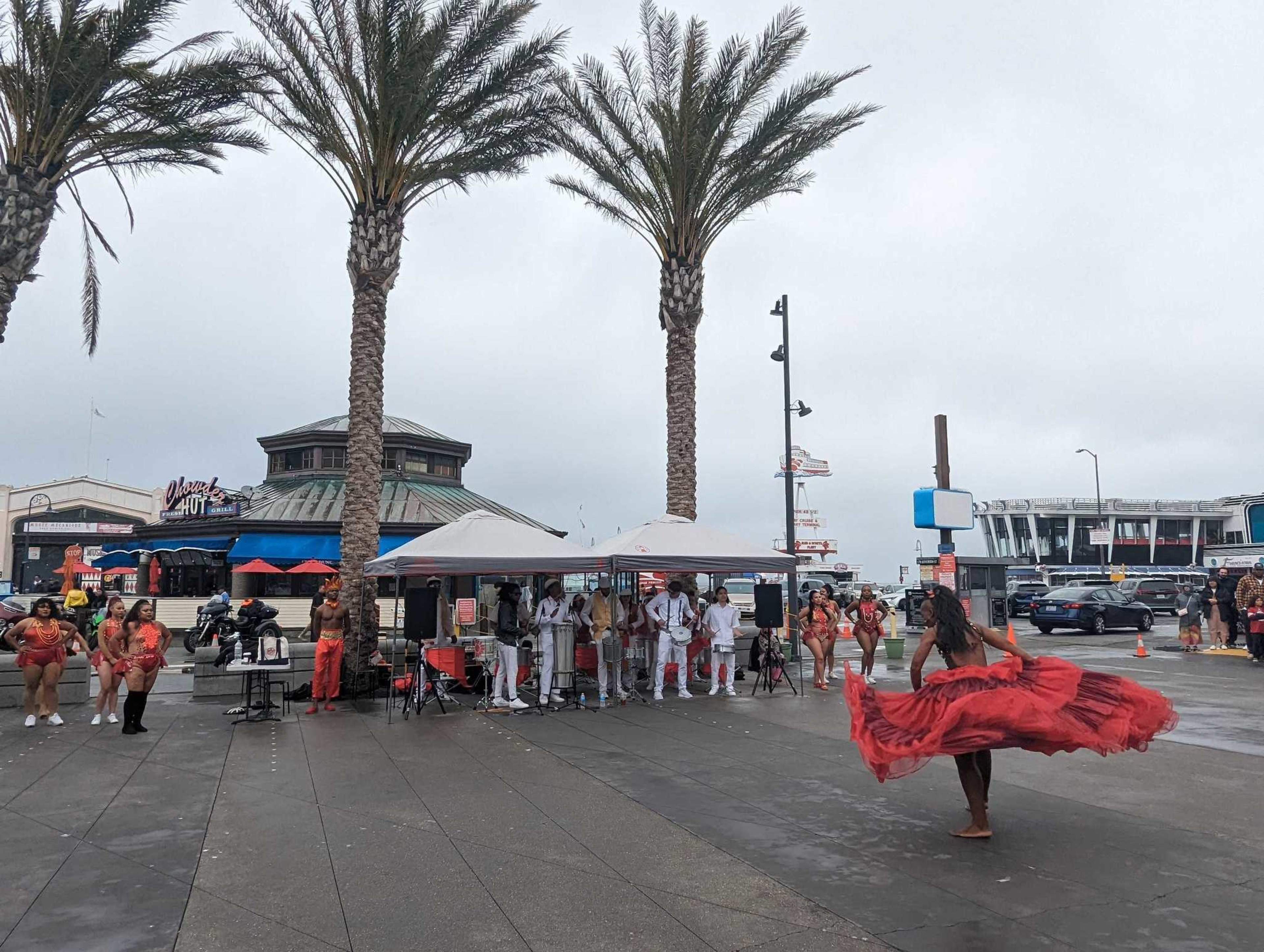 Loco Bloco dancers and musicians perform at Crab Wheel Plaza at Fishermen's Wharf for the San Francisco Trolley Dances festival on Sunday, October 22, 2023. Epiphany’s San Francisco Trolley Dances (SFTD) is an annual festival presented over 3 days along a designated public transit route. SFTD connects neighborhoods and participants to San Francisco’s history, culture, architecture, natural environment and social fabric.