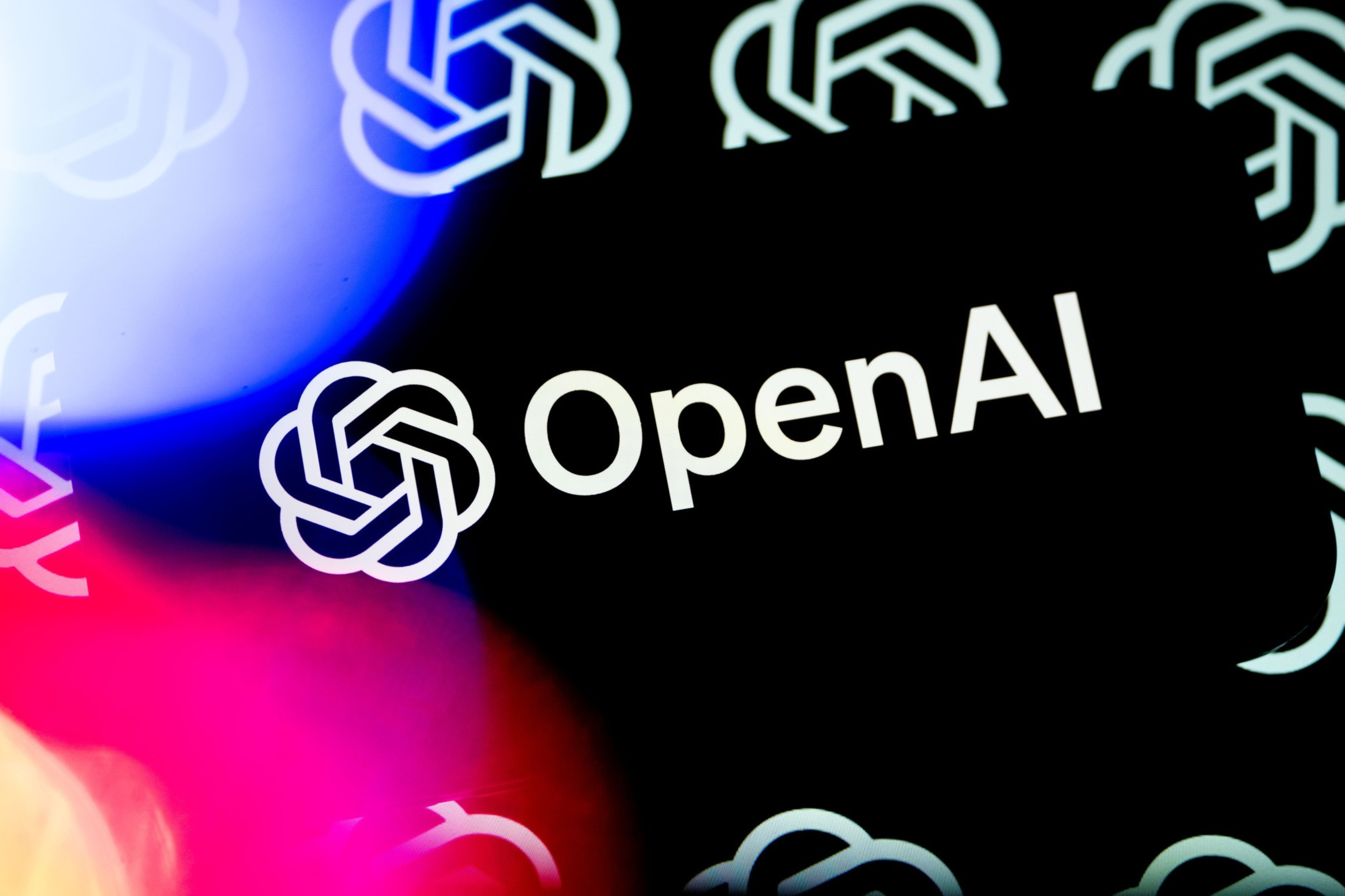 The image shows the OpenAI logo with interlocking lines, accompanied by the text "OpenAI." The background features multiple blurred versions of the logo.