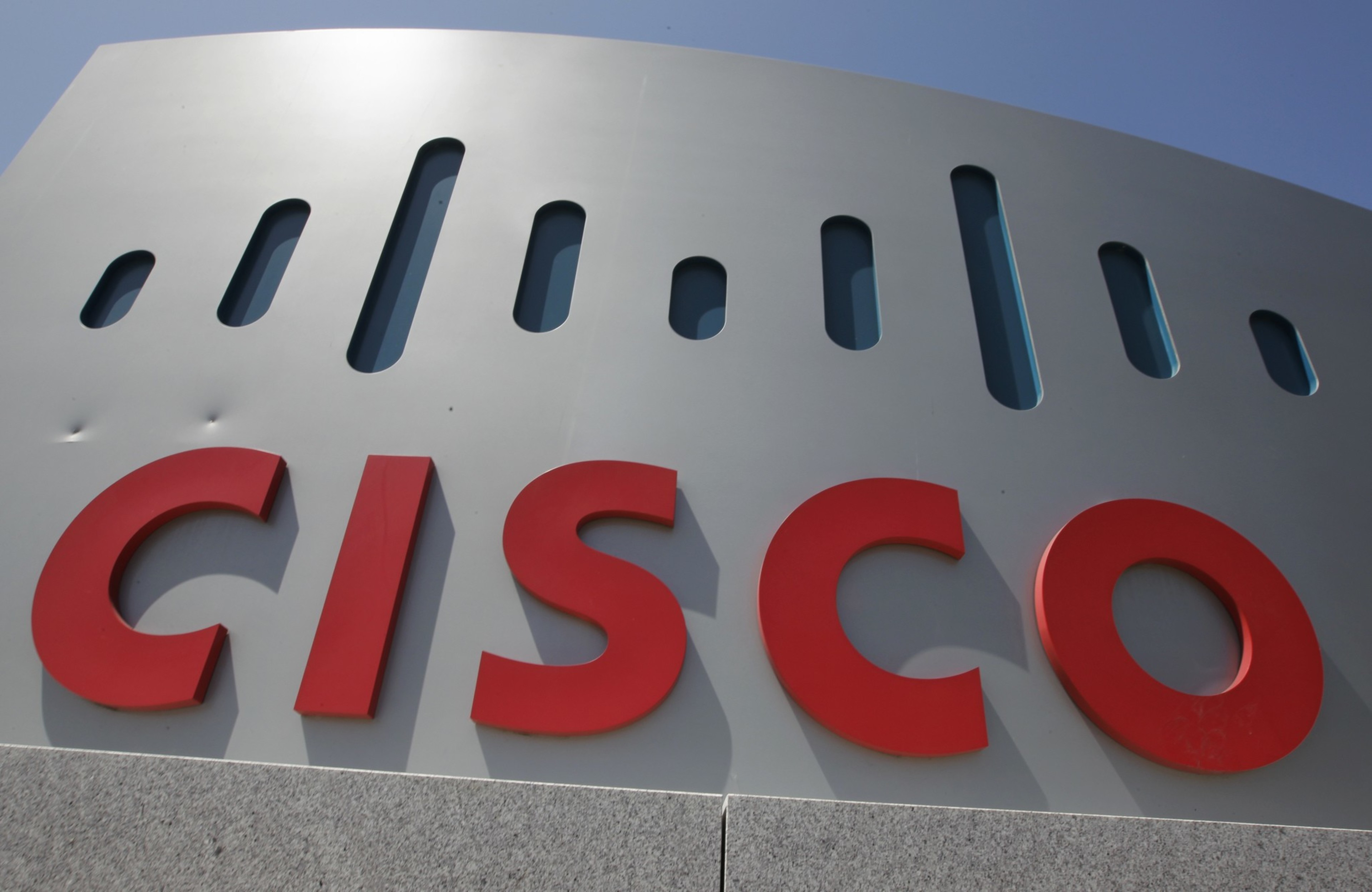 A gray and red sign for Cisco outside the company headquarters