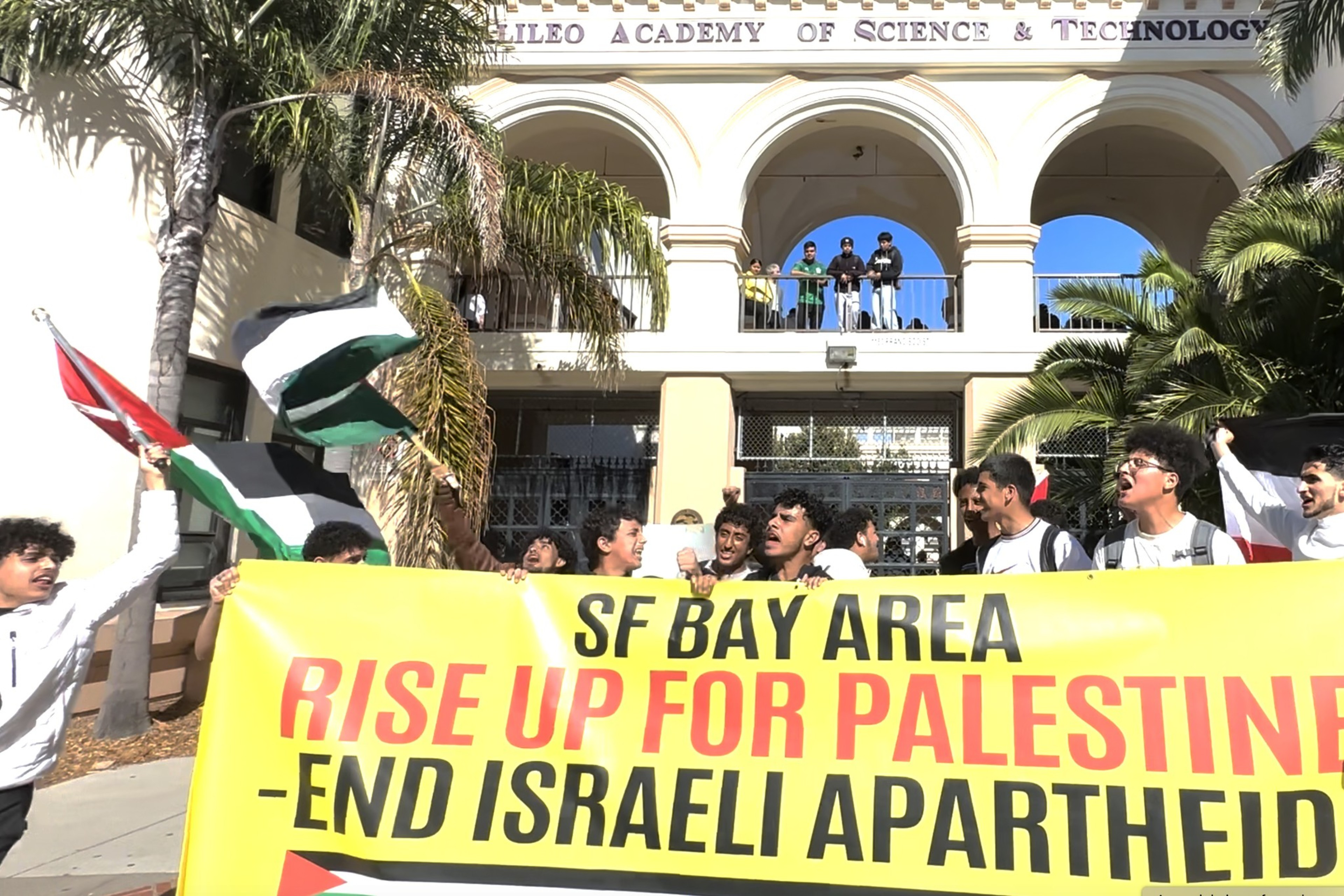 Students hold up a banner that reads "Rise Up for Palestine."