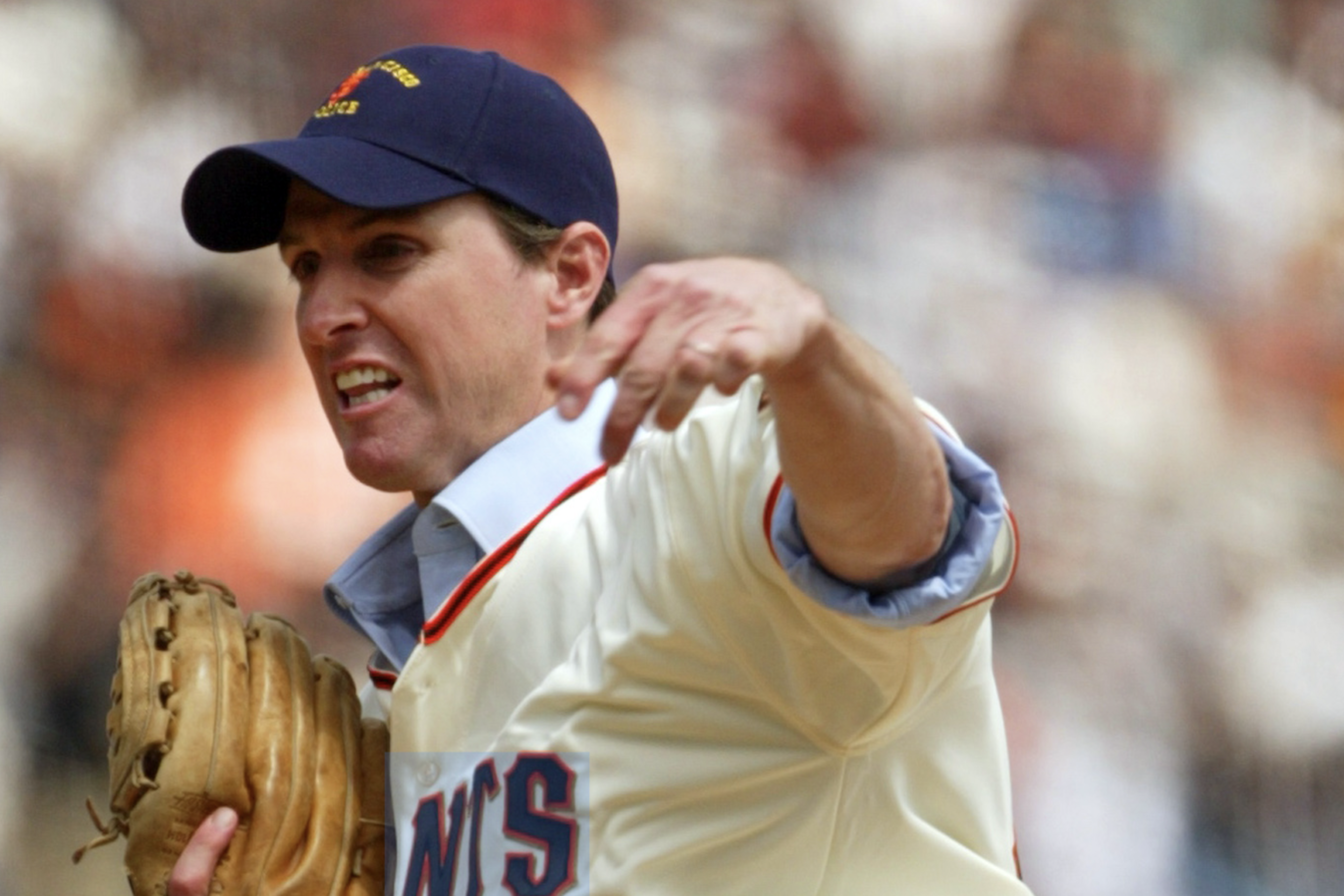 Gavin Newsom throwing a baseball