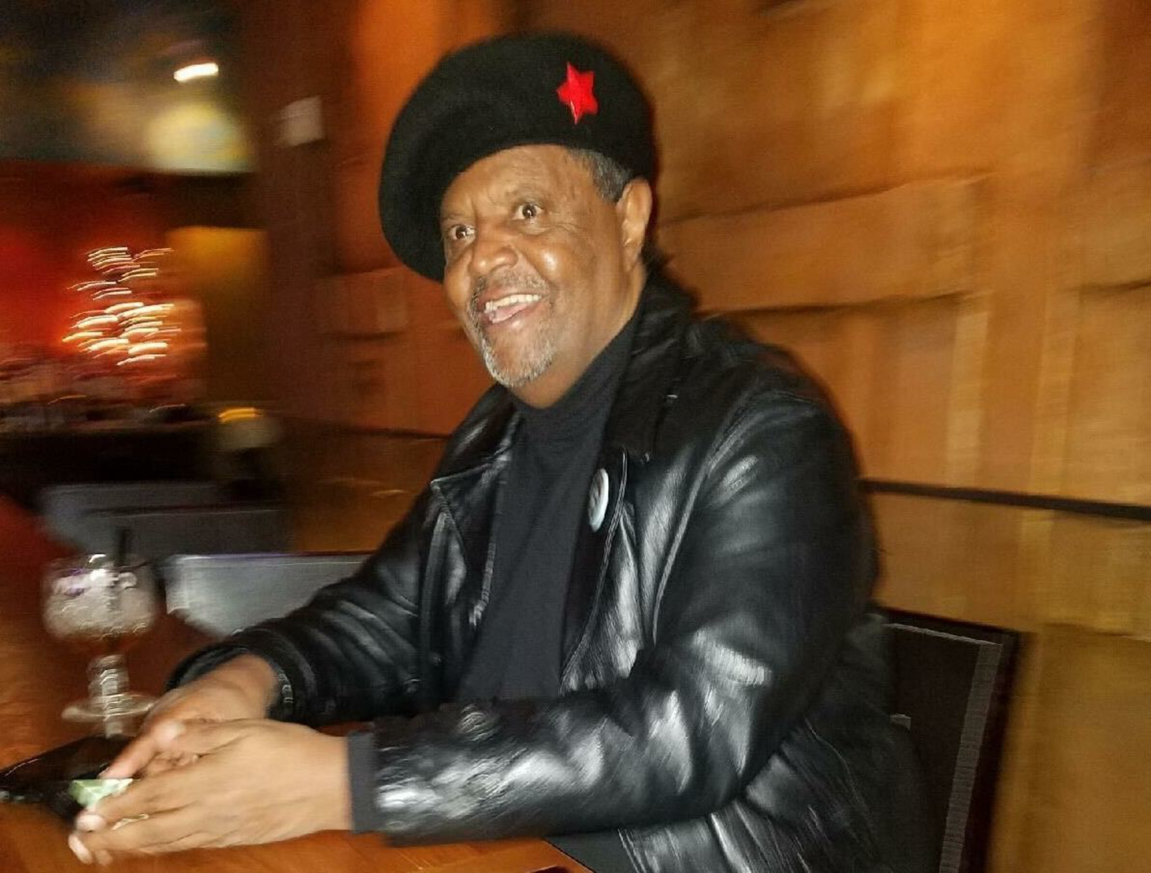 Agonafer Shiferaw enjoying a drink while sitting inside of the Sheba Piano Lounge owned by his wife, Net Alemayehu.