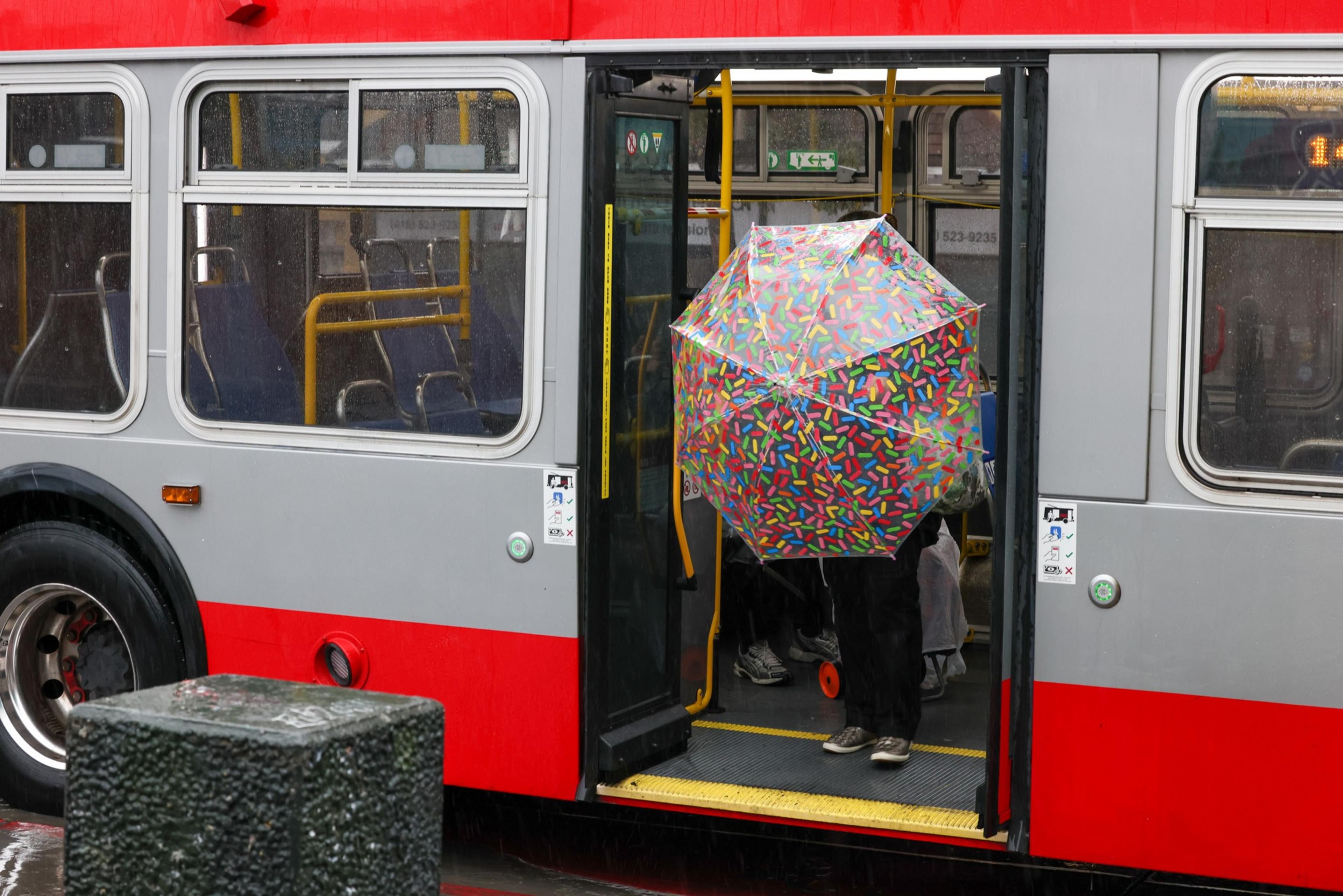 Pedestrians descend the Muni bus at Mission and 24th streets in San Francisco. | Camille Cohen/The Standard