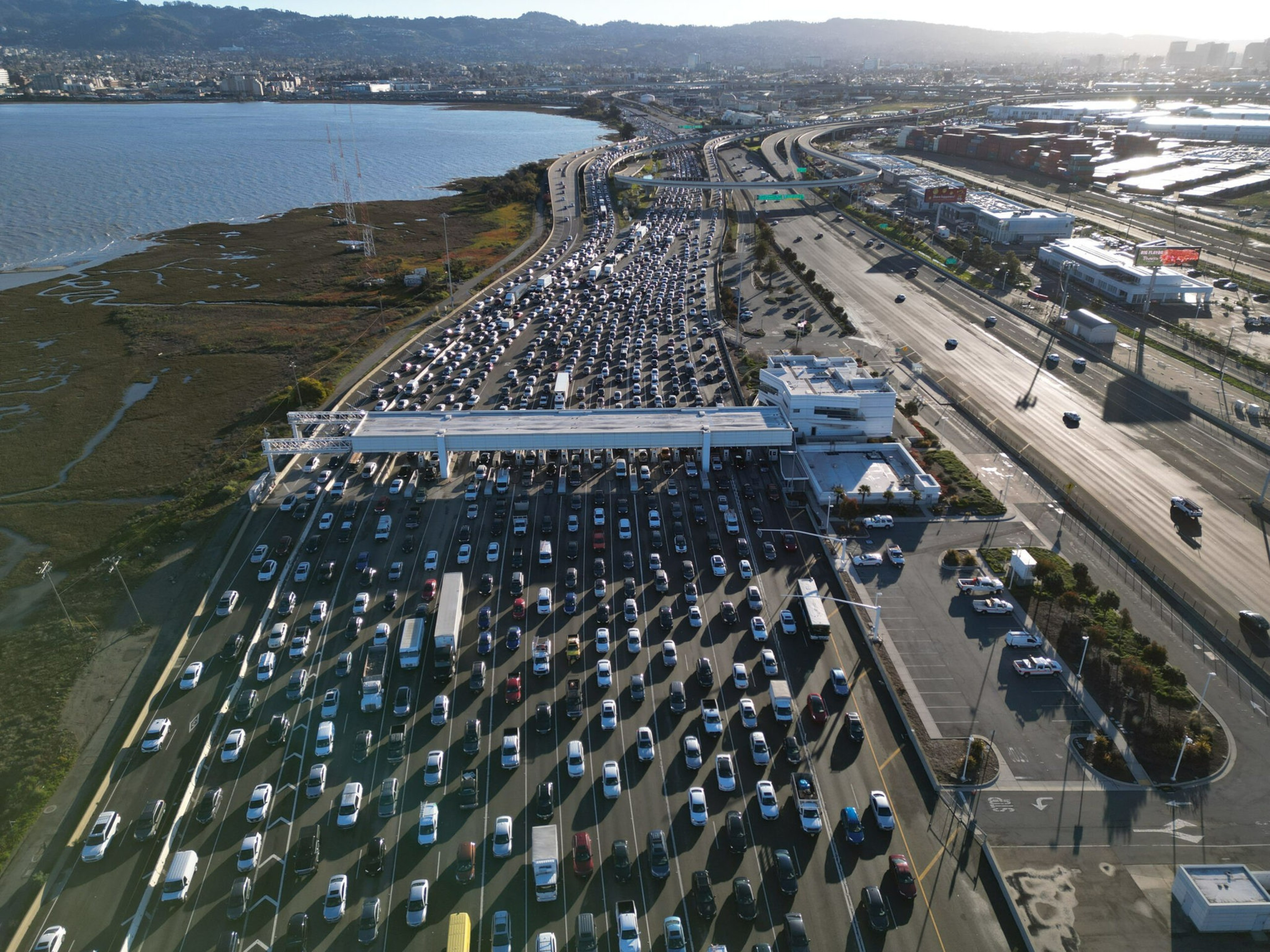 Vehicles driving into San Francisco are backed up at the toll plaza.