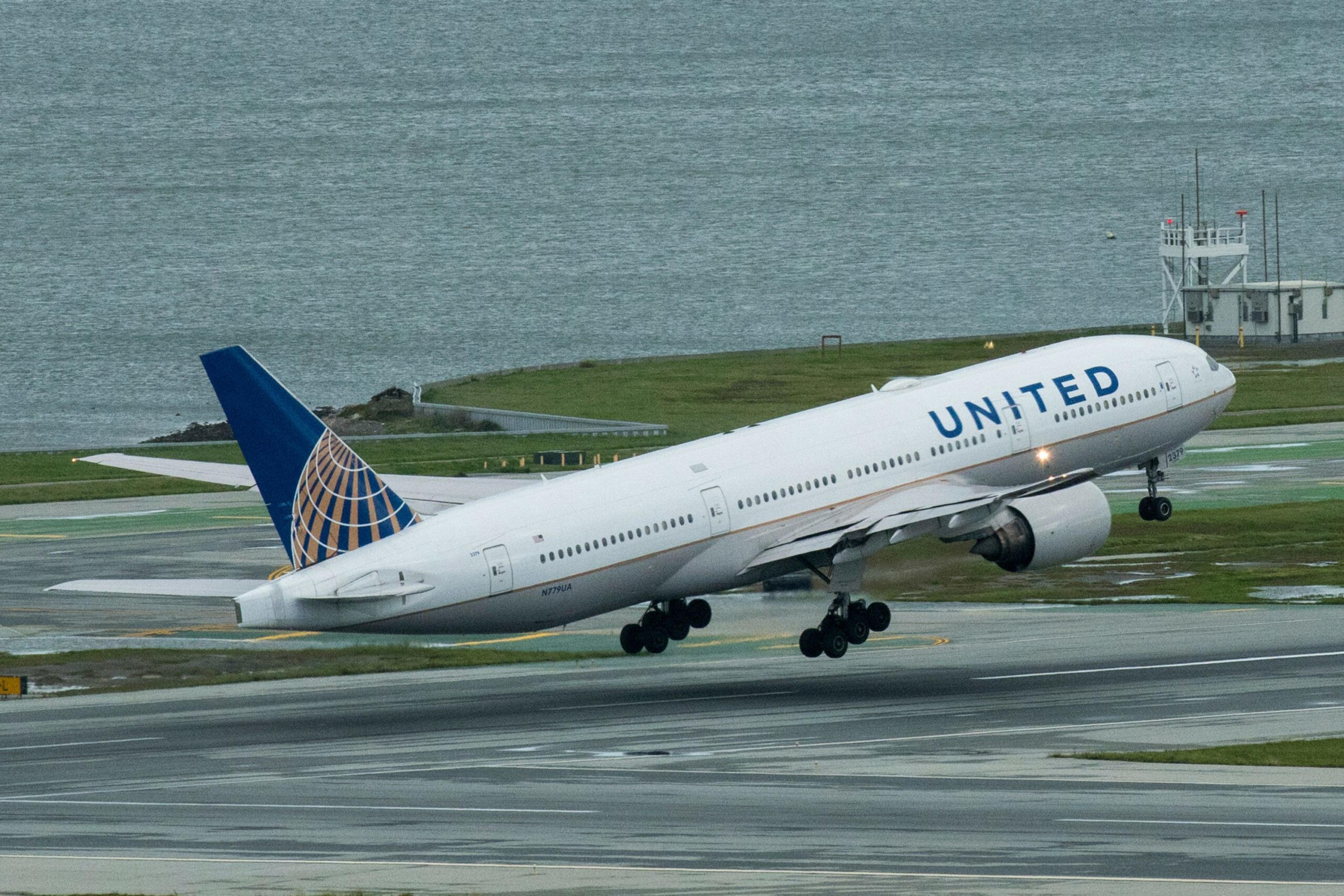 A plane hovers above an airport runway.