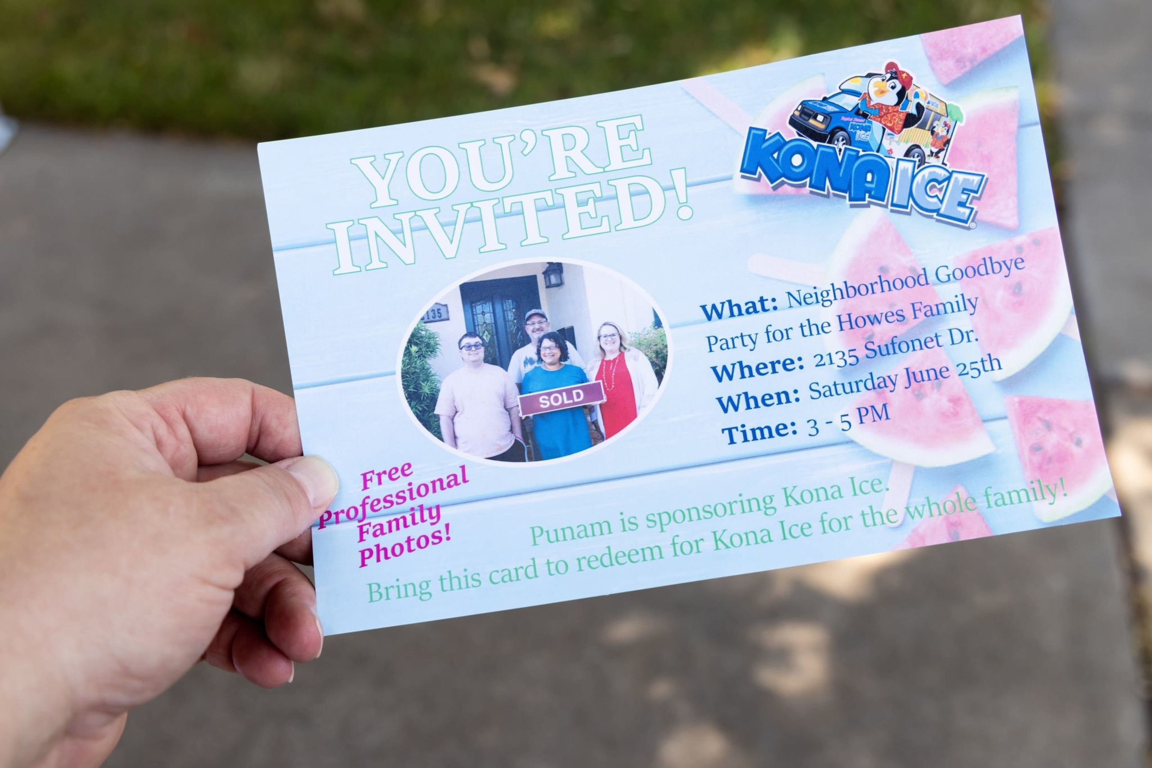 A hand holds an invitation to a neighborhood goodbye party.